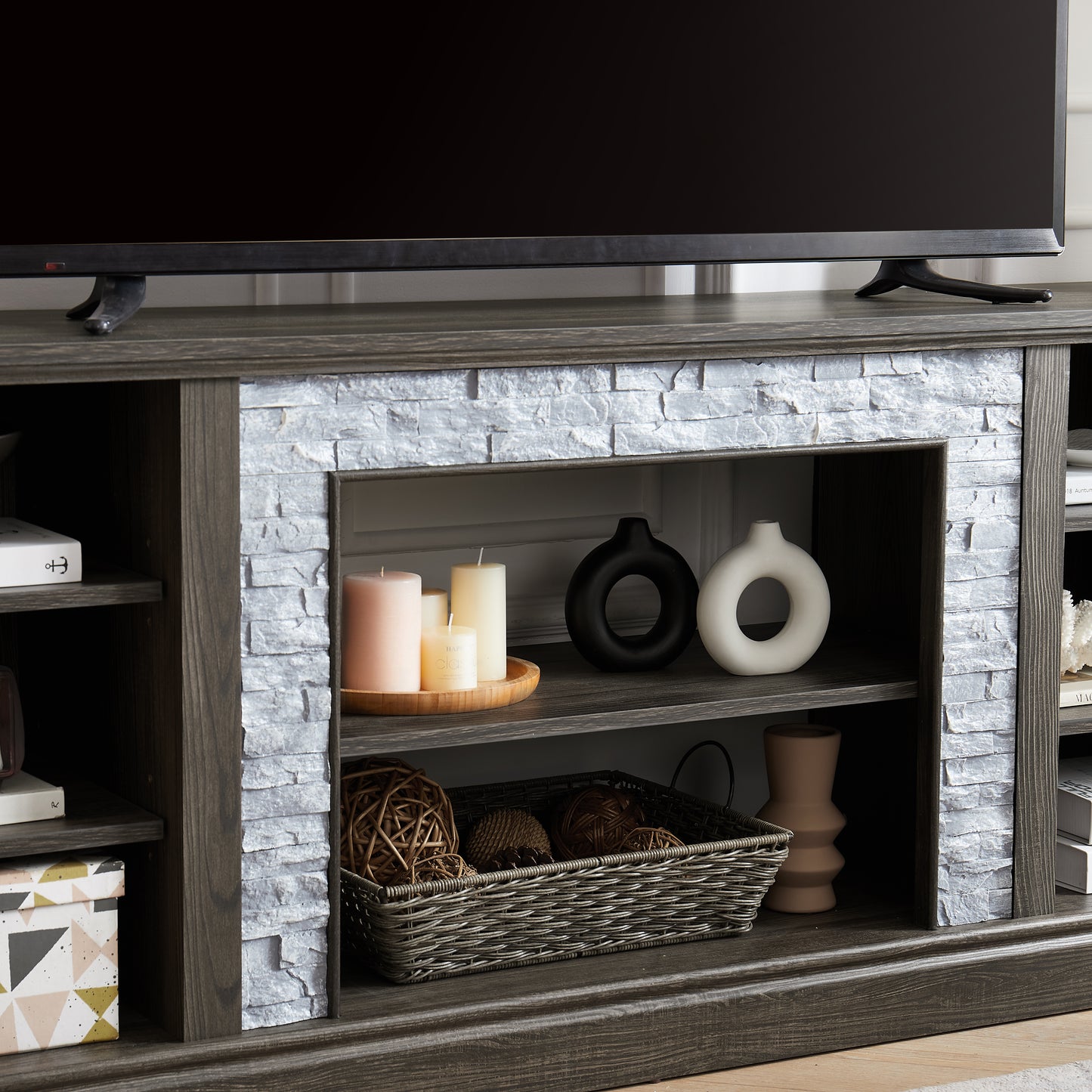 Rustic gray wood TV stand with stone veneer accents and ample shelving space