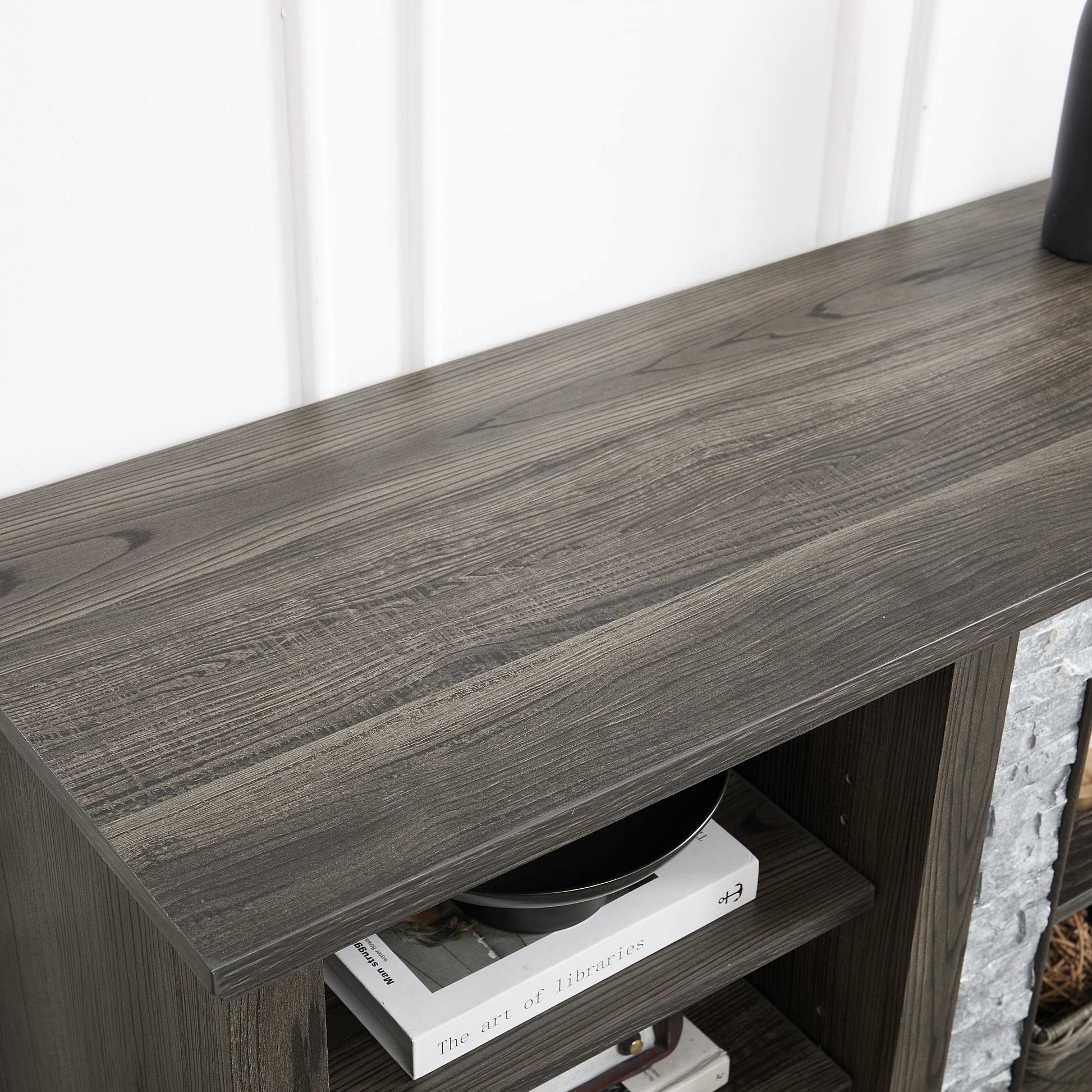 Dark wood TV stand with textured gray stone accents and open shelving