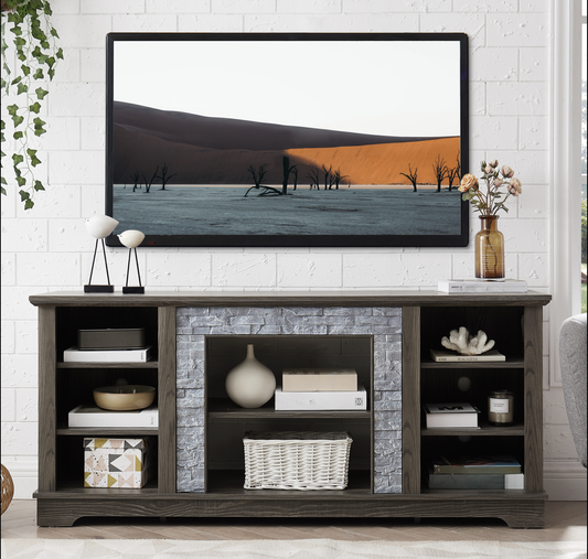 Dark wood TV stand with gray stone fireplace surround and open shelves displaying decor