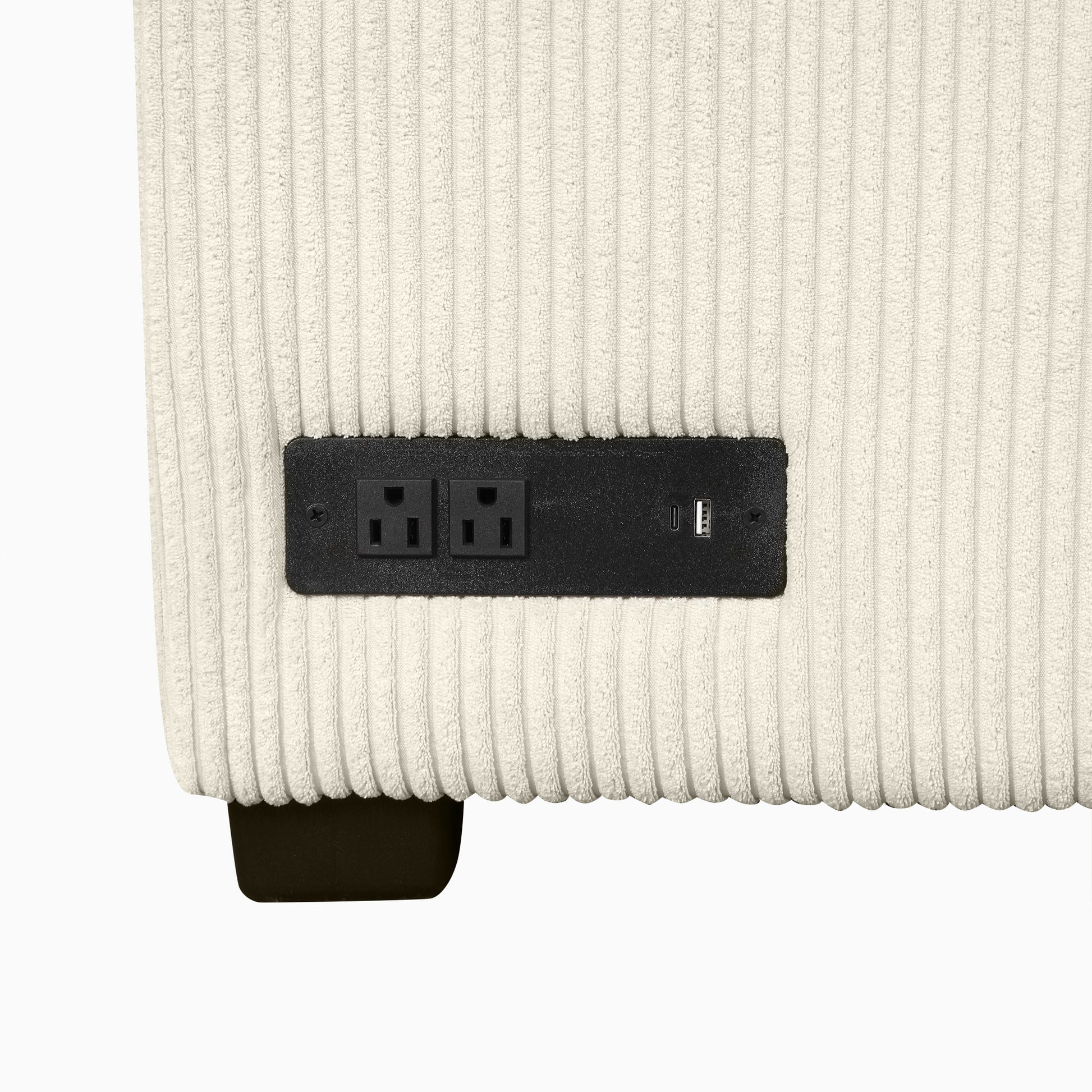 Cream corduroy sofa side with integrated power outlet and USB charger