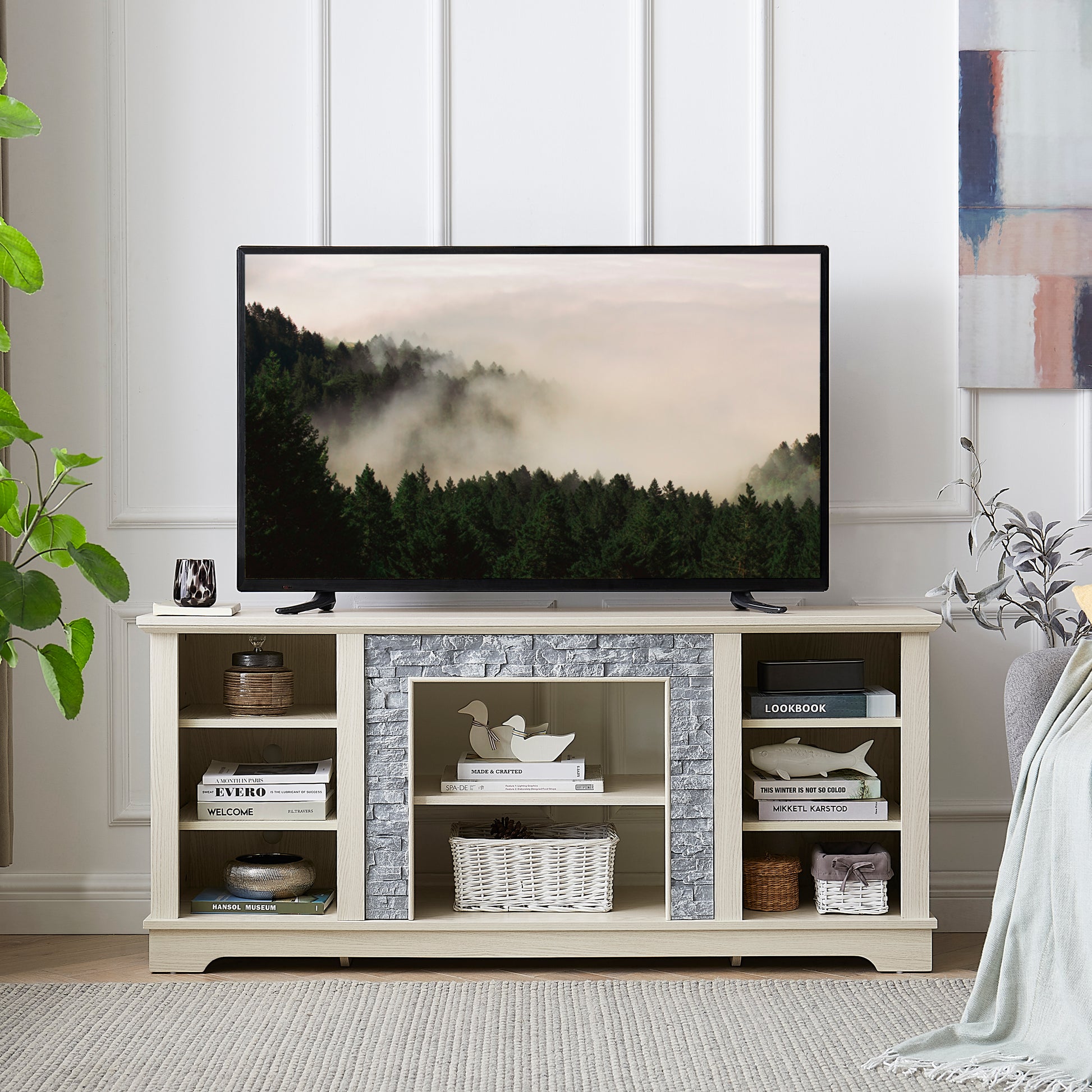 Light oak TV stand with stone accents and open shelving holding decorative items and books