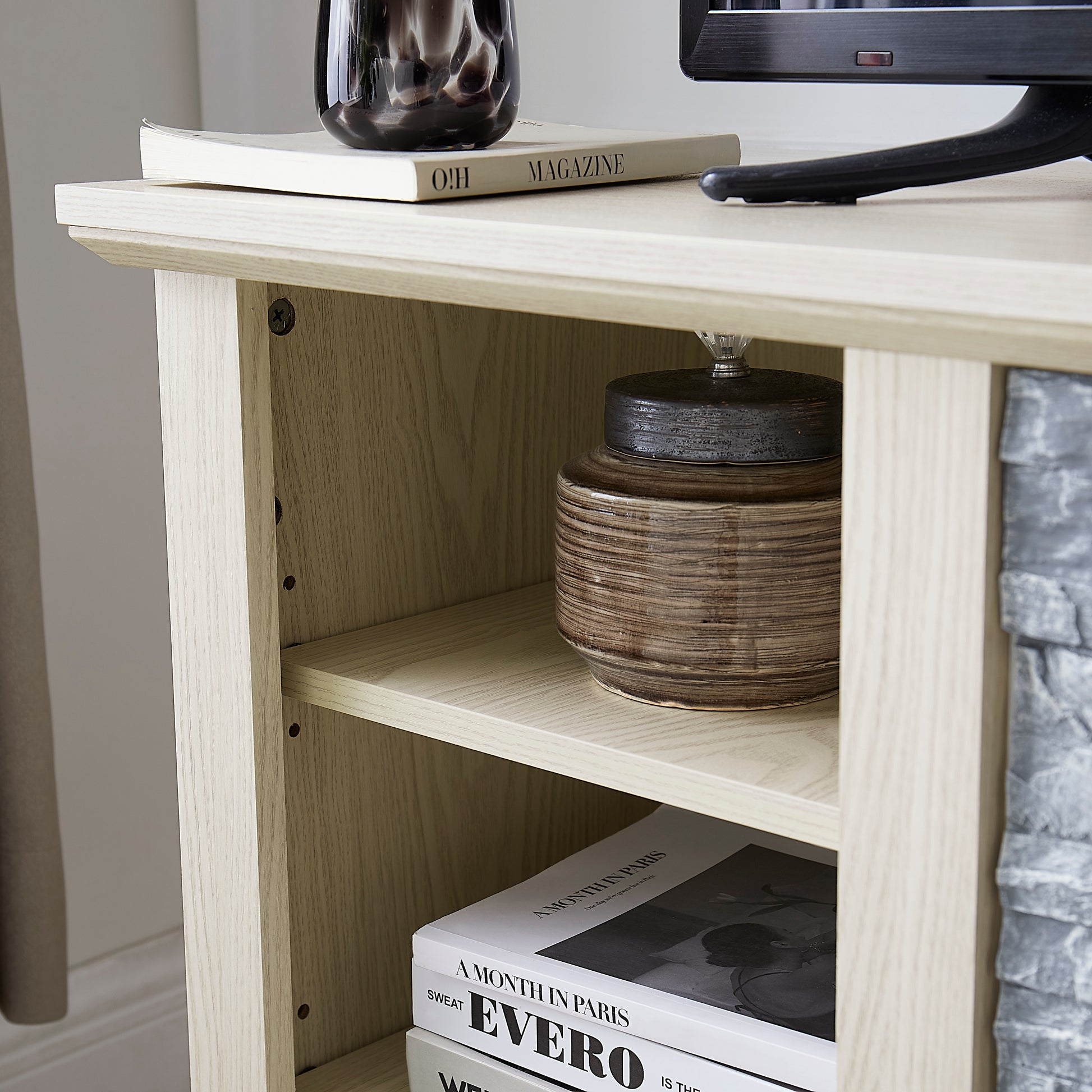 Light oak effect media unit shelf with decorative ceramic jar and magazine