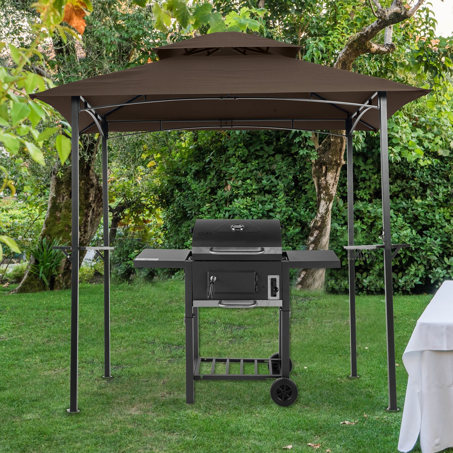 Brown doubletier gazebo with a black charcoal grill on a grassy backyard lawn