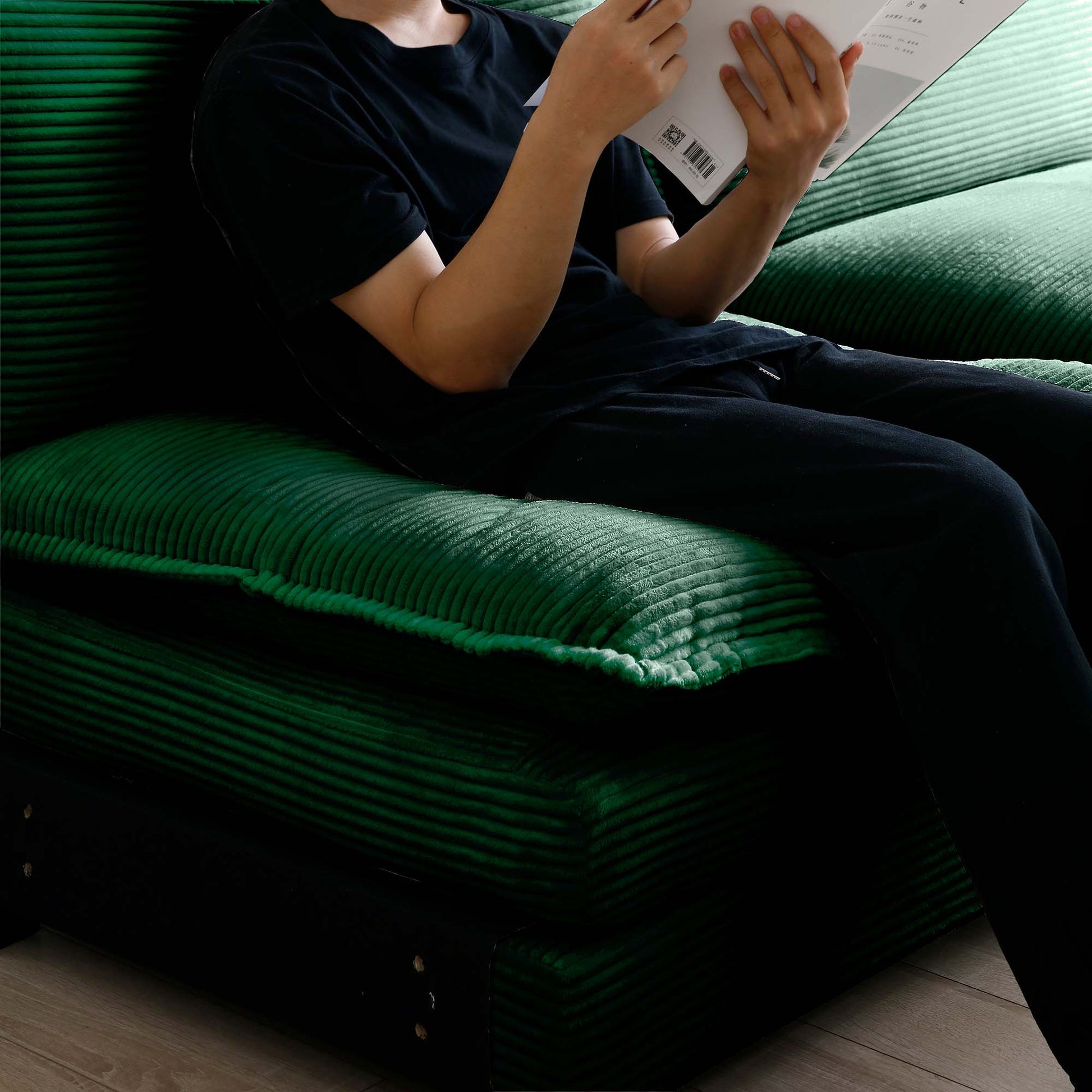 Deep green corduroy sofa cushion with plush texture perfect for a cozy living room setup