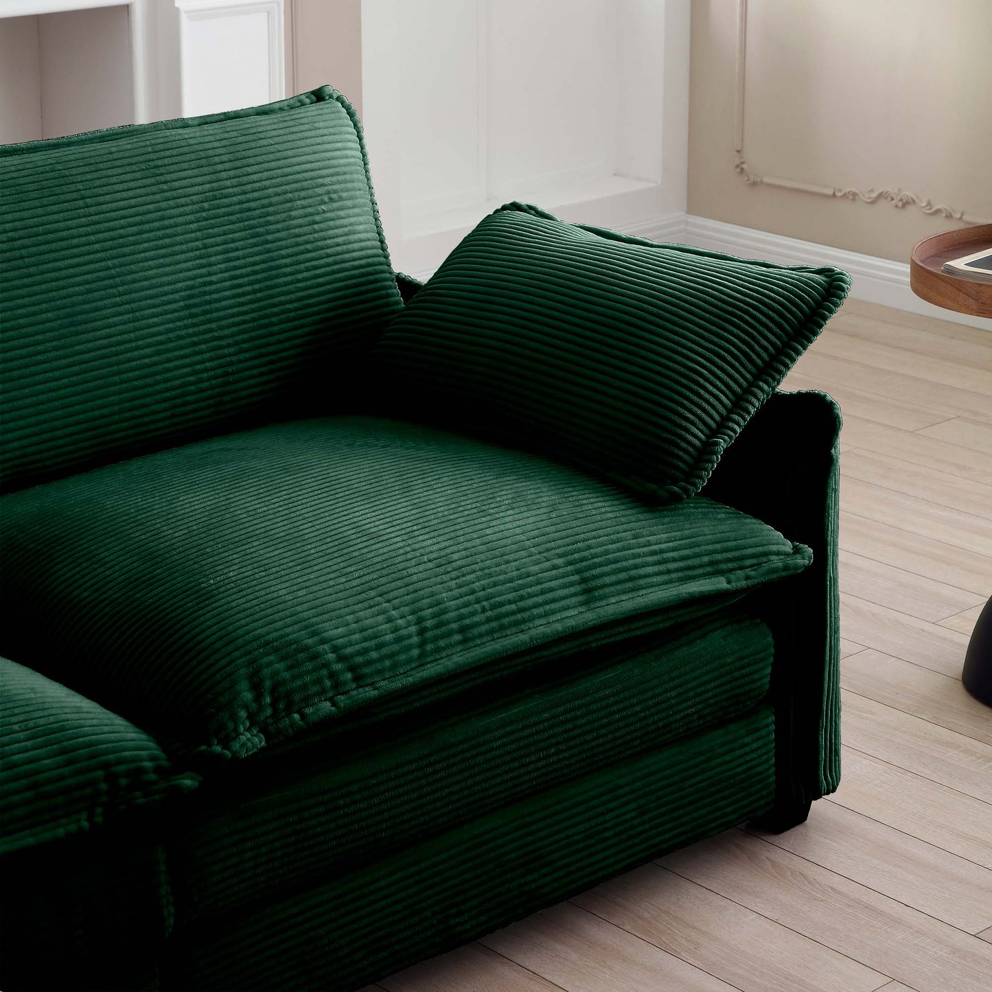 Deep green corduroy sectional sofa with plush cushions and contemporary design