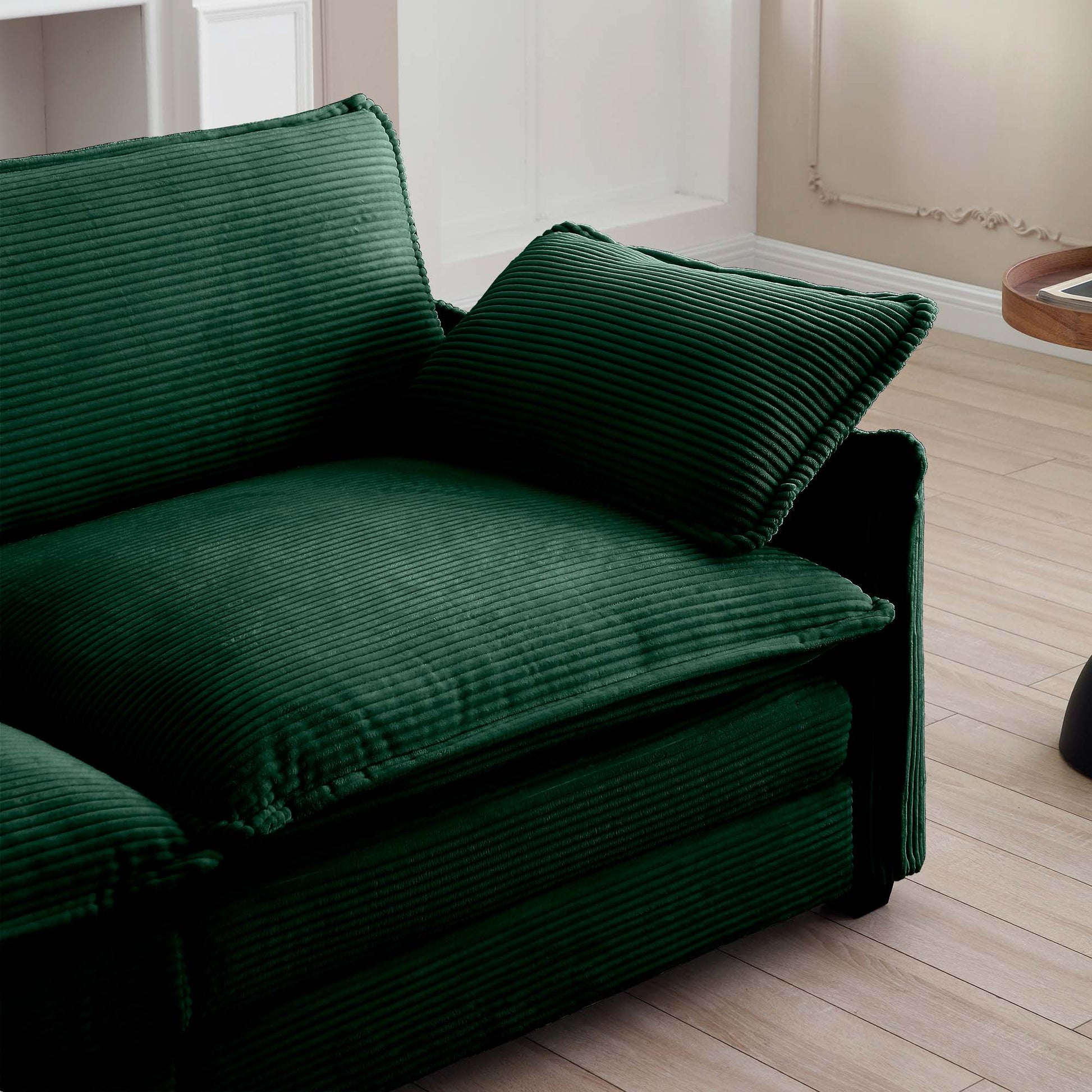 Deep green corduroy sectional sofa with plush cushions and contemporary design