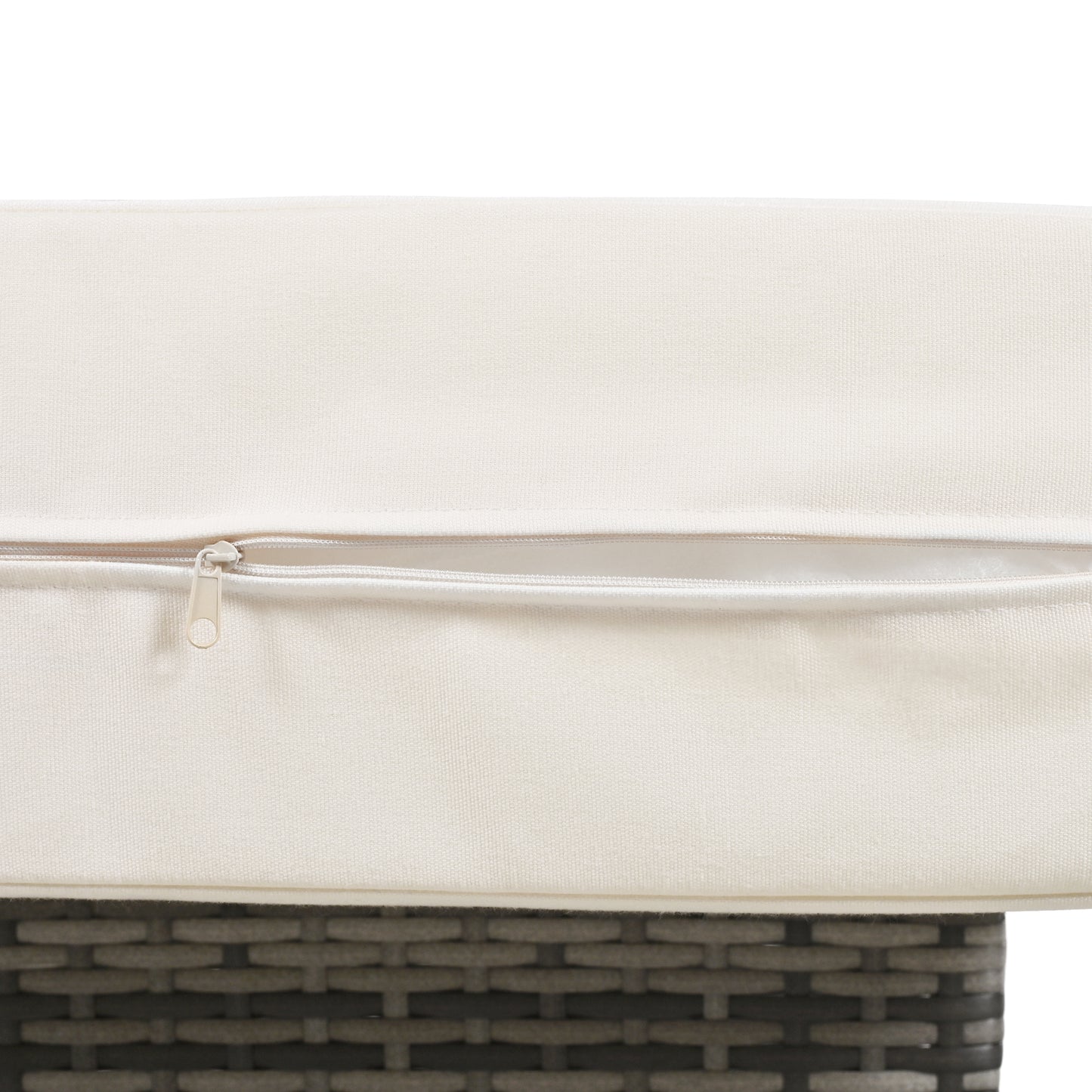 Closeup of ivory outdoor cushion with a white zipper detail on wicker furniture