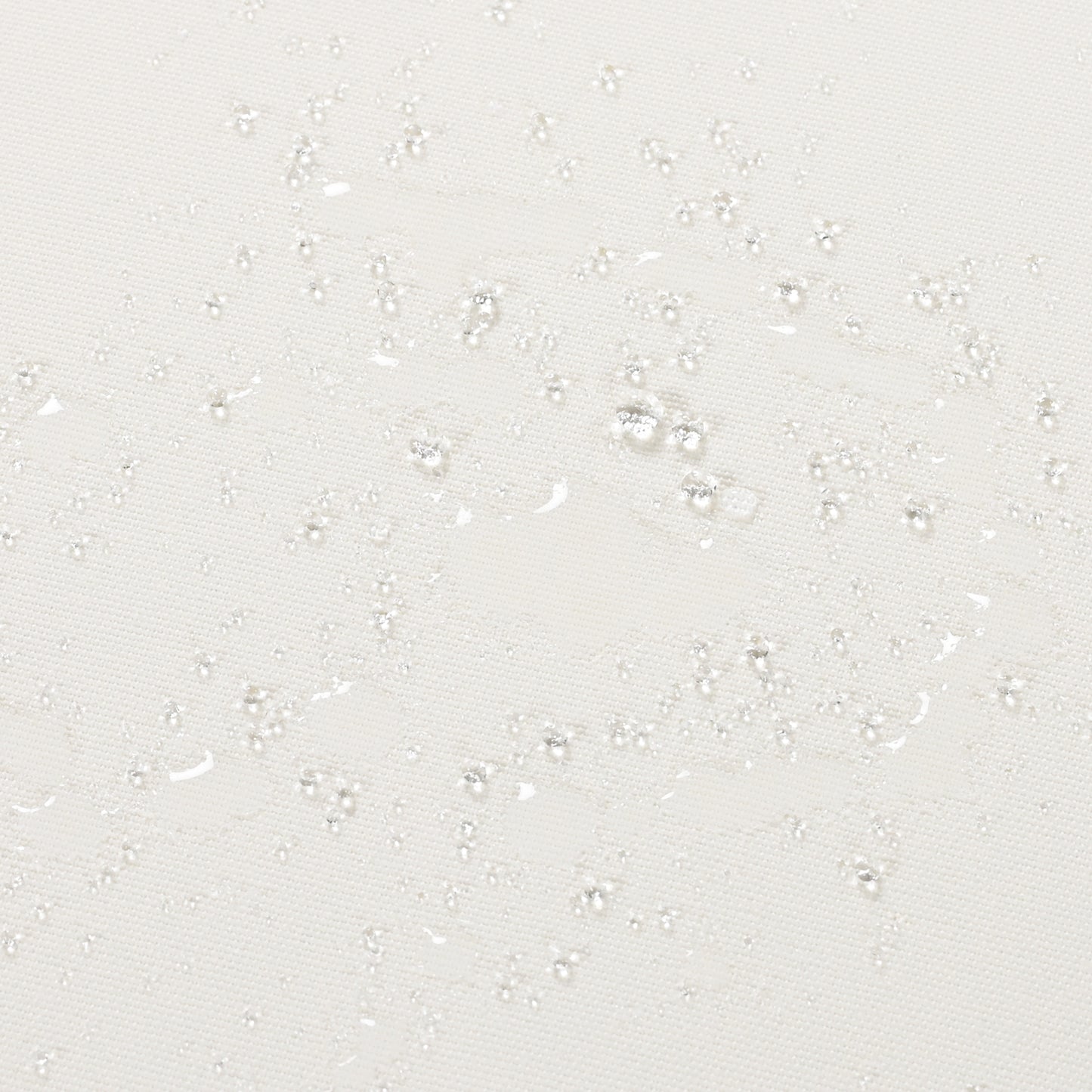 Closeup of a white textured fabric with water droplets showcasing its waterrepellent property