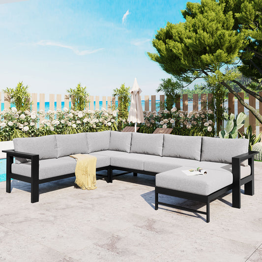 Gray modular outdoor sofa with black frame and yellow throw blanket perfect for patios
