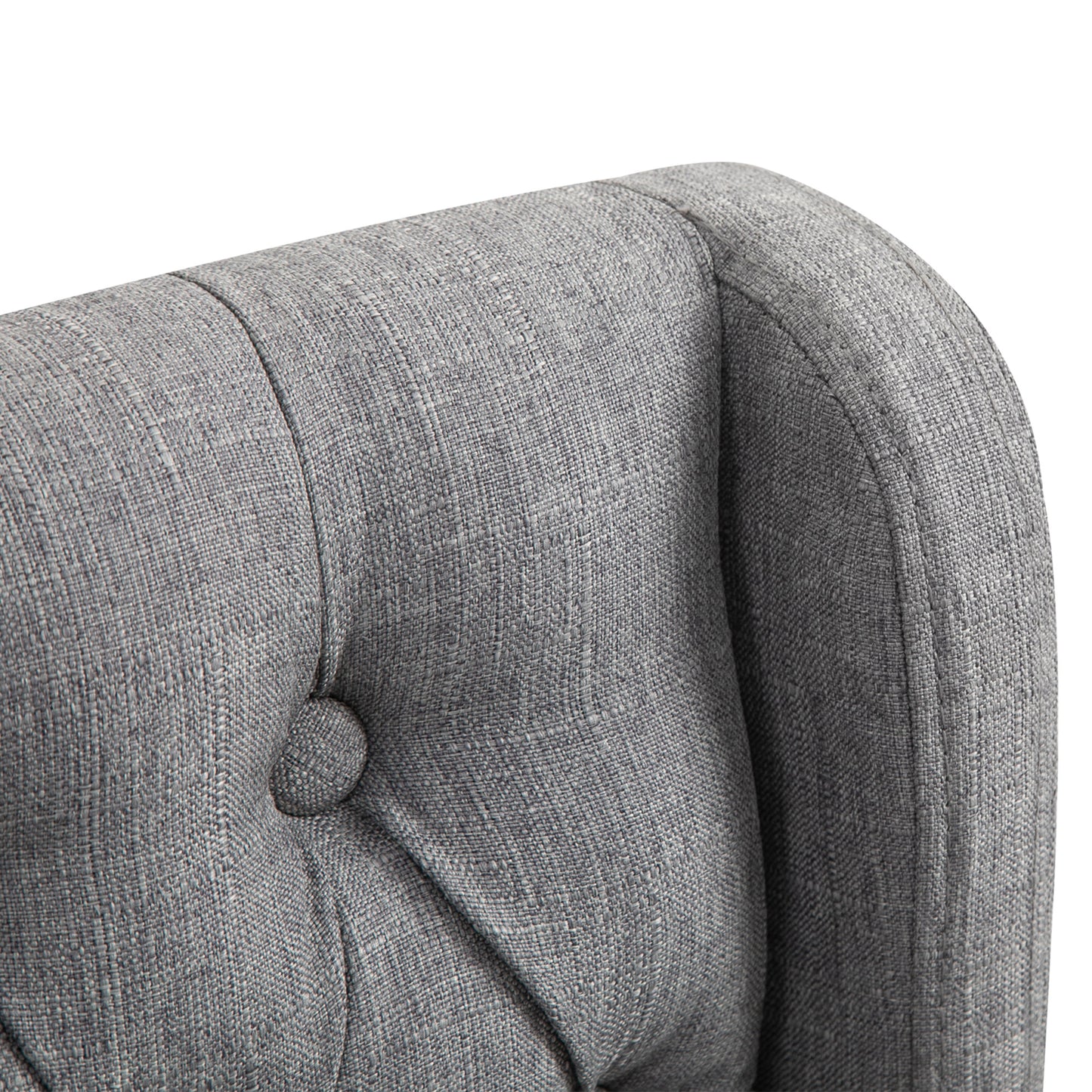 Closeup of grey tufted armchair fabric showing detailed texture and button accent for stylish living room decor