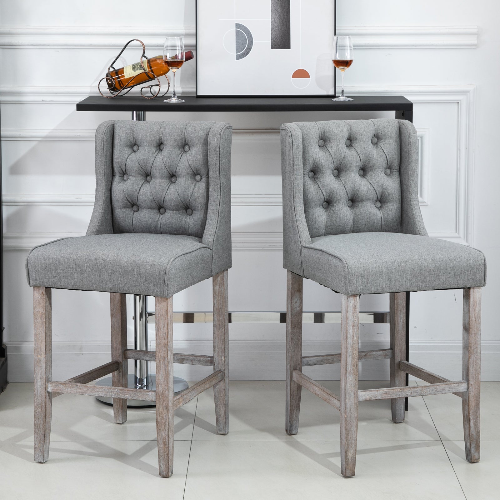 Gray upholstered bar stool with diamond tufting and weathered wood legs