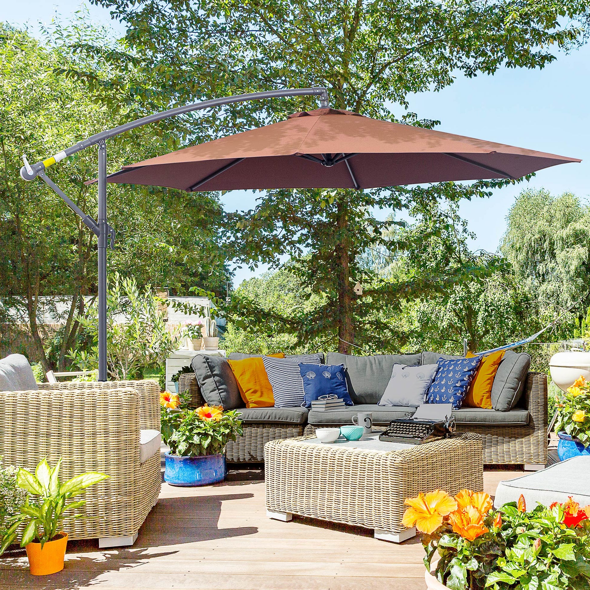 Large brown cantilever umbrella providing shade over a wicker patio furniture set and coffee table