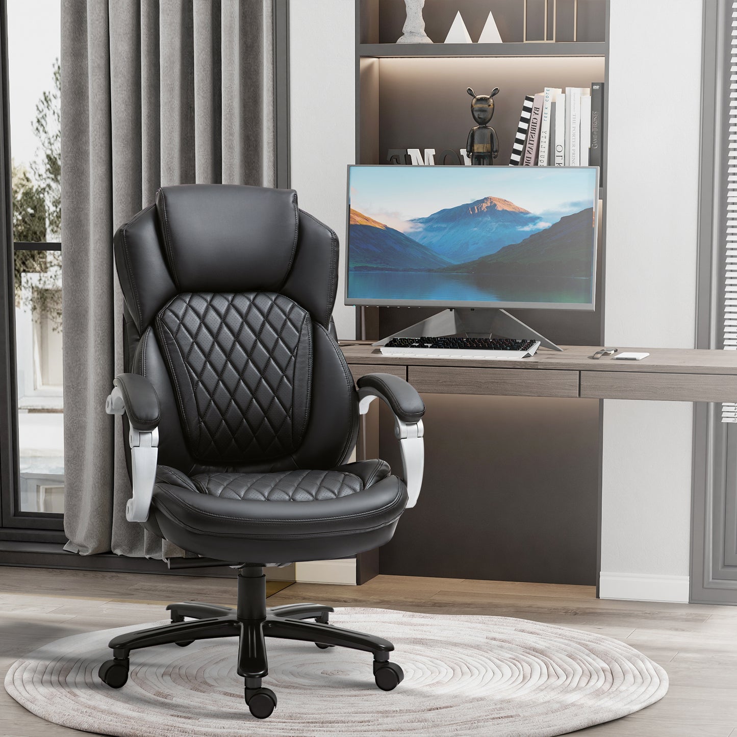 Ergonomic black leather office chair with quilted padding and silver accents