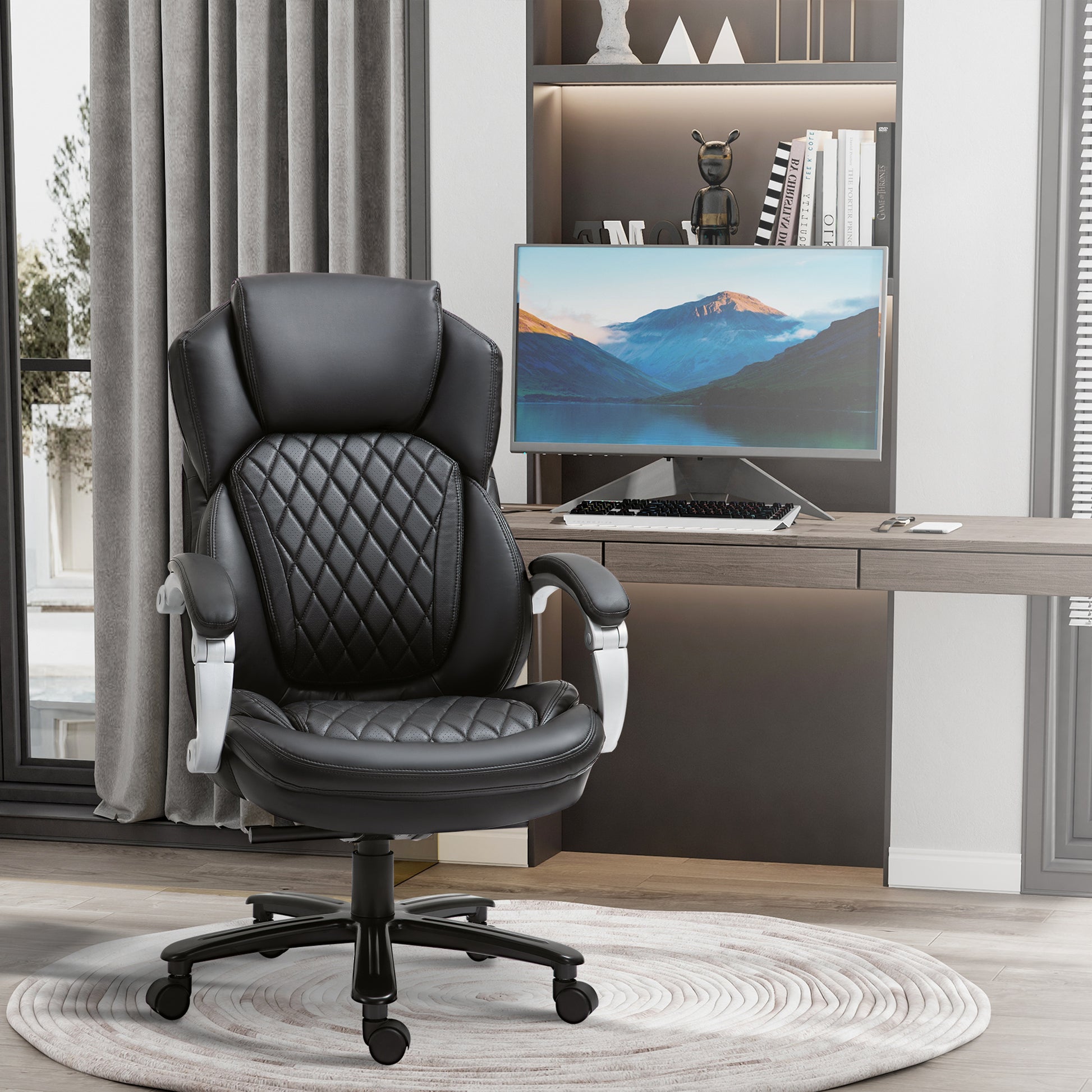 Ergonomic black leather office chair with quilted padding and silver accents