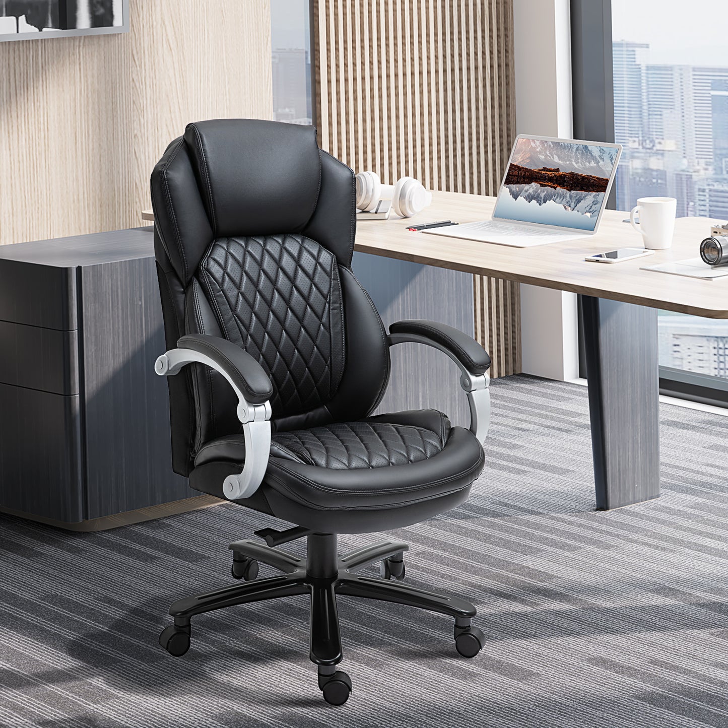 Black executive office chair with quilted PU leather and silver armrests