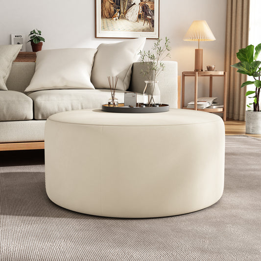 Cream fabric ottoman plush and round perfect for living room seating or coffee table use