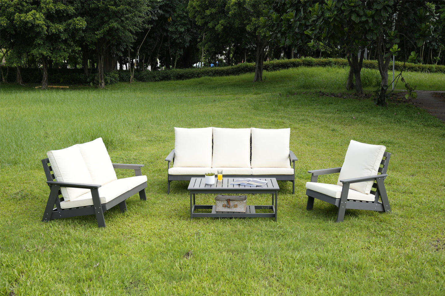 Dark gray patio sofa with plush offwhite cushions for outdoor relaxation