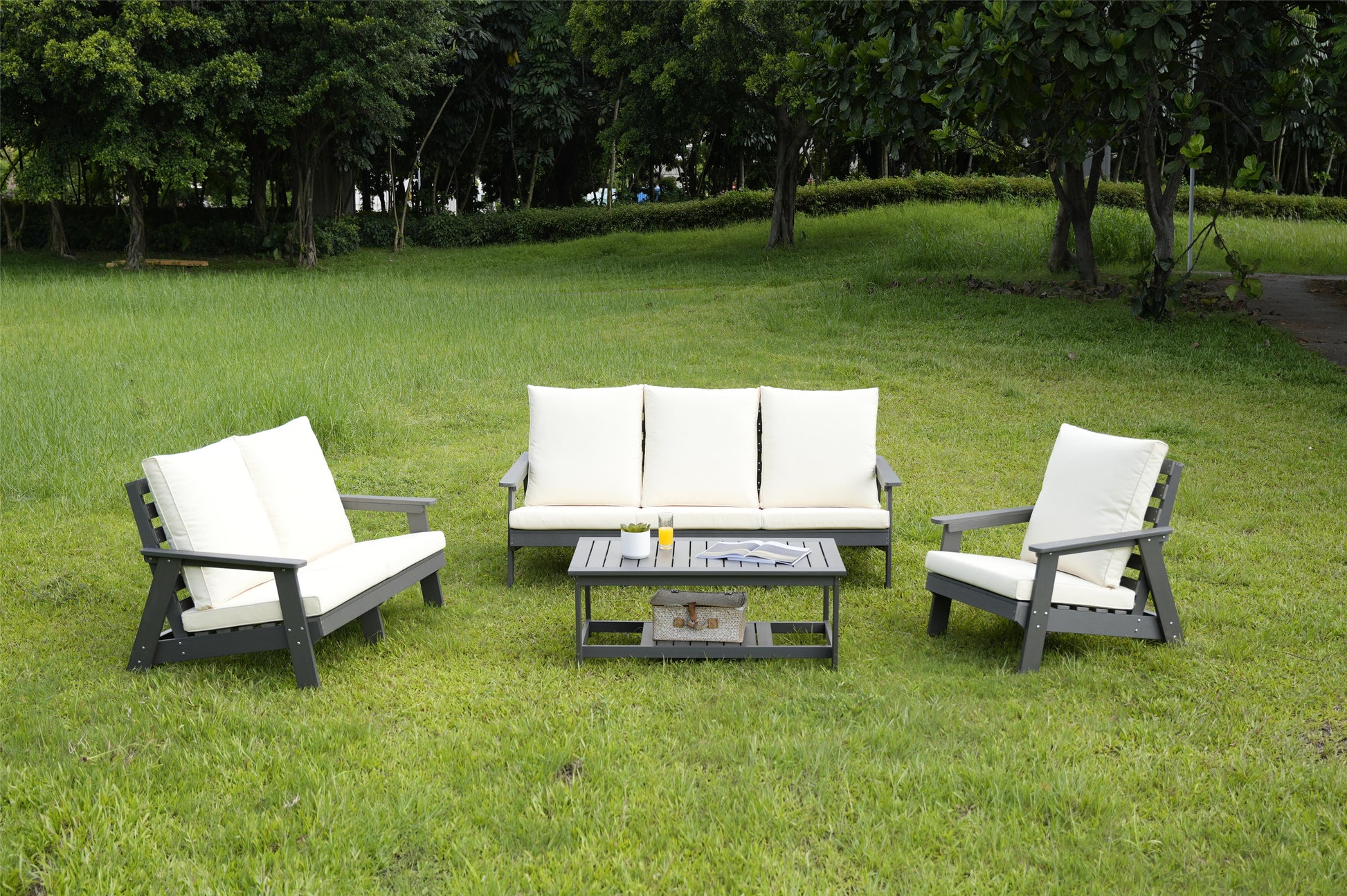 Dark gray patio sofa with plush offwhite cushions for outdoor relaxation