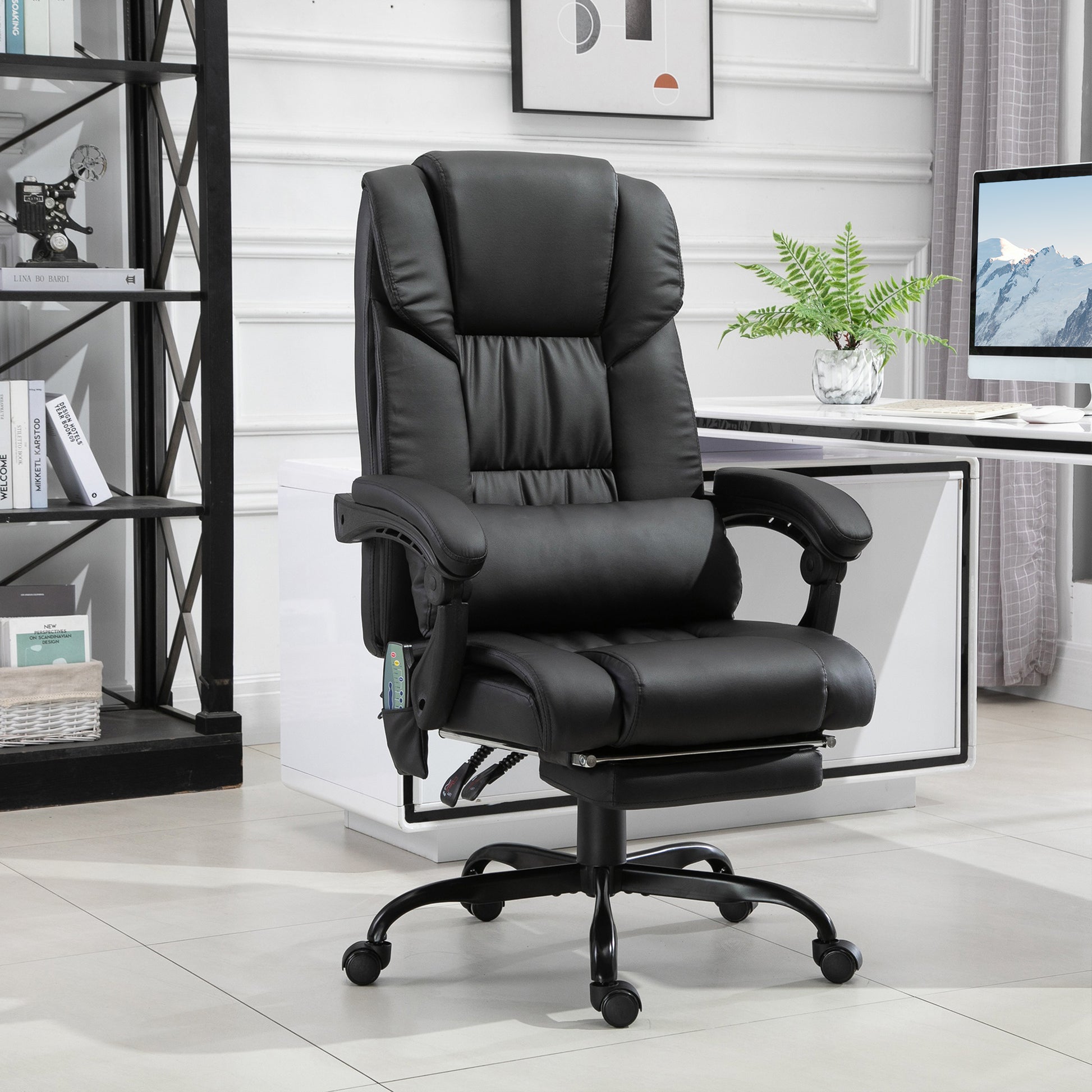 Black ergonomic office chair with lumbar support and footrest