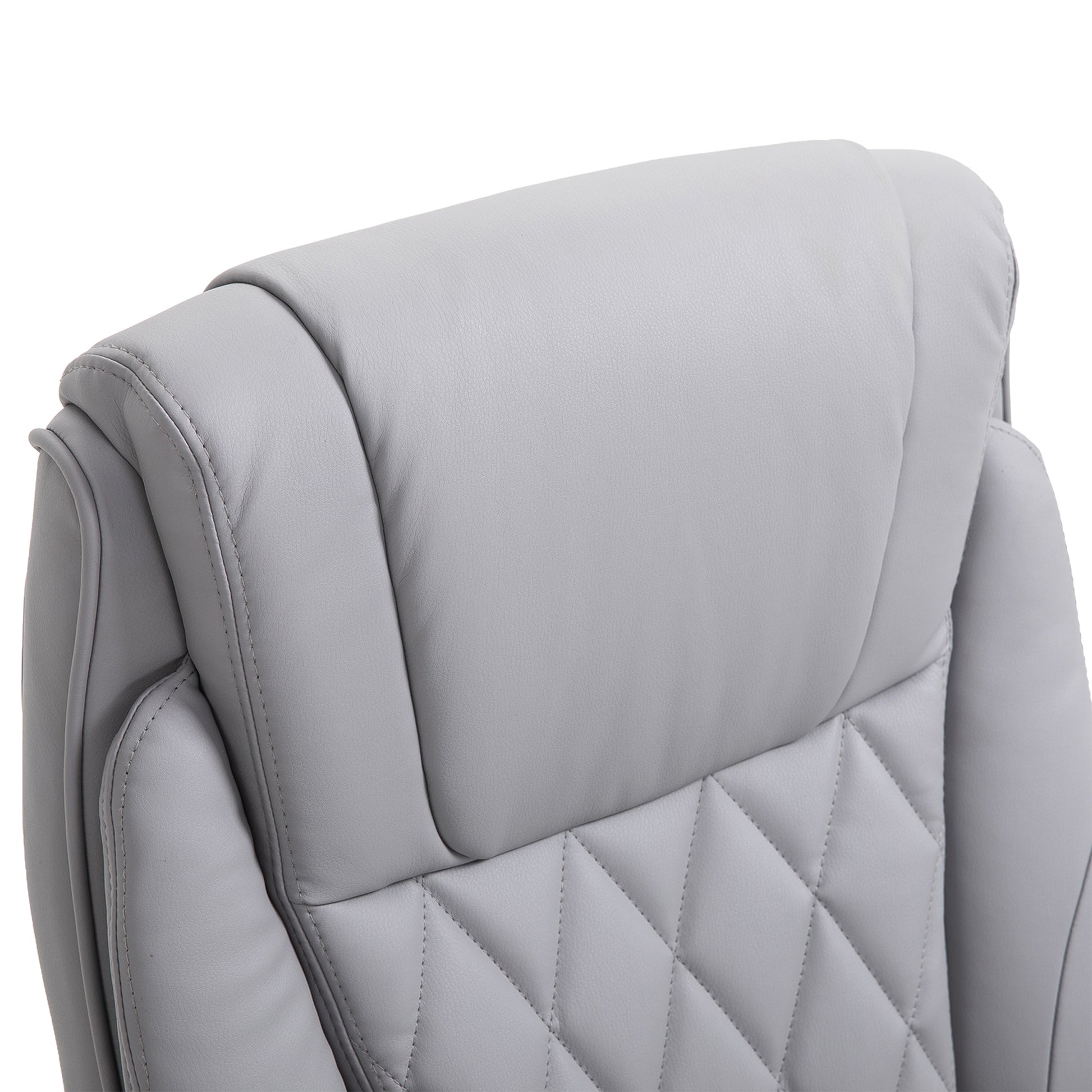 Closeup of a light gray faux leather executive office chair headrest with diamond stitching detail