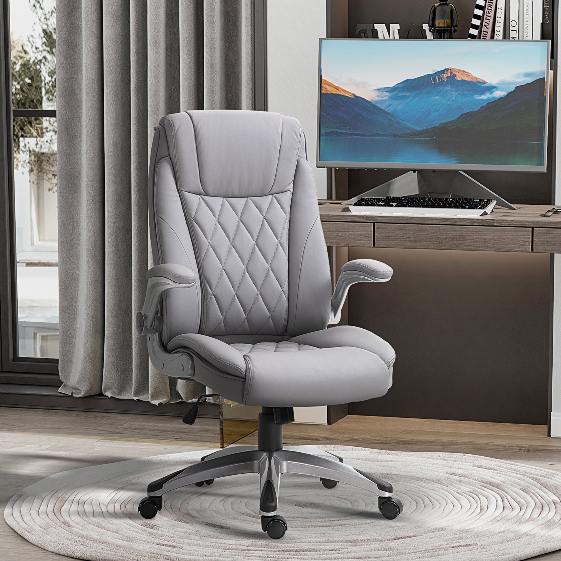 Gray executive office chair with diamond stitching and padded armrests