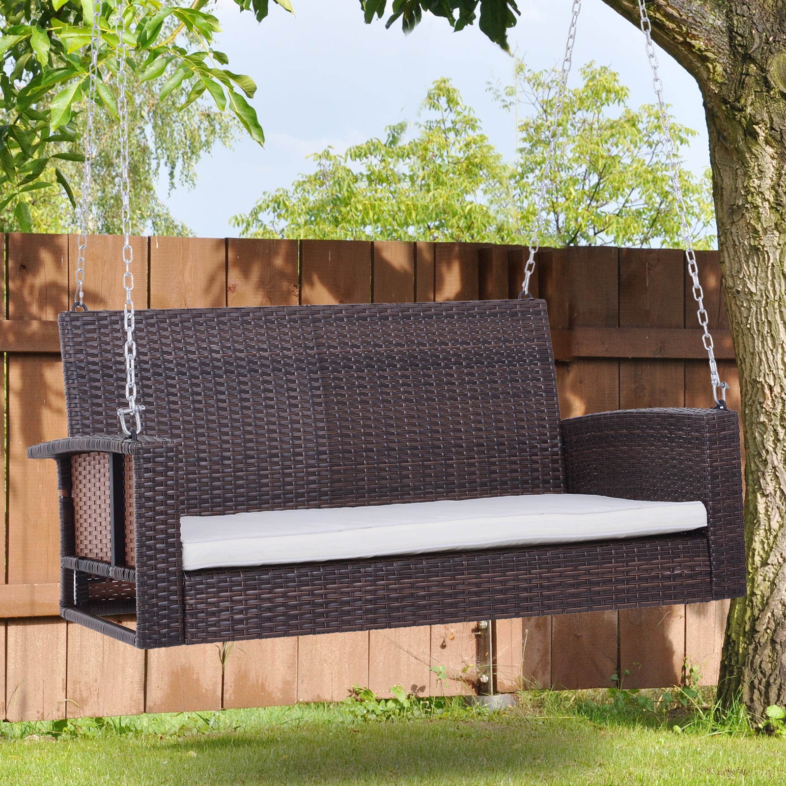 Dark brown rattan porch swing with white cushion perfect for outdoor seating
