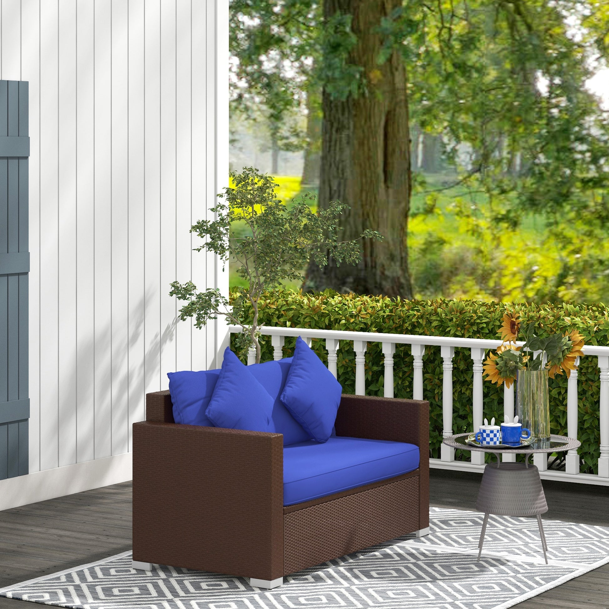 Brown wicker loveseat with bright blue cushions on a deck perfect for outdoor relaxation