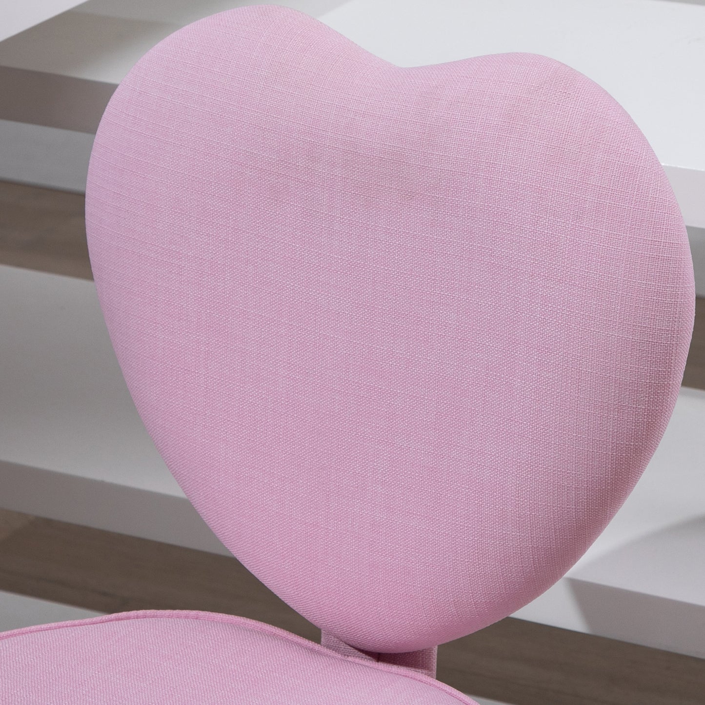 Pink upholstered heartshaped chair back for a childs desk