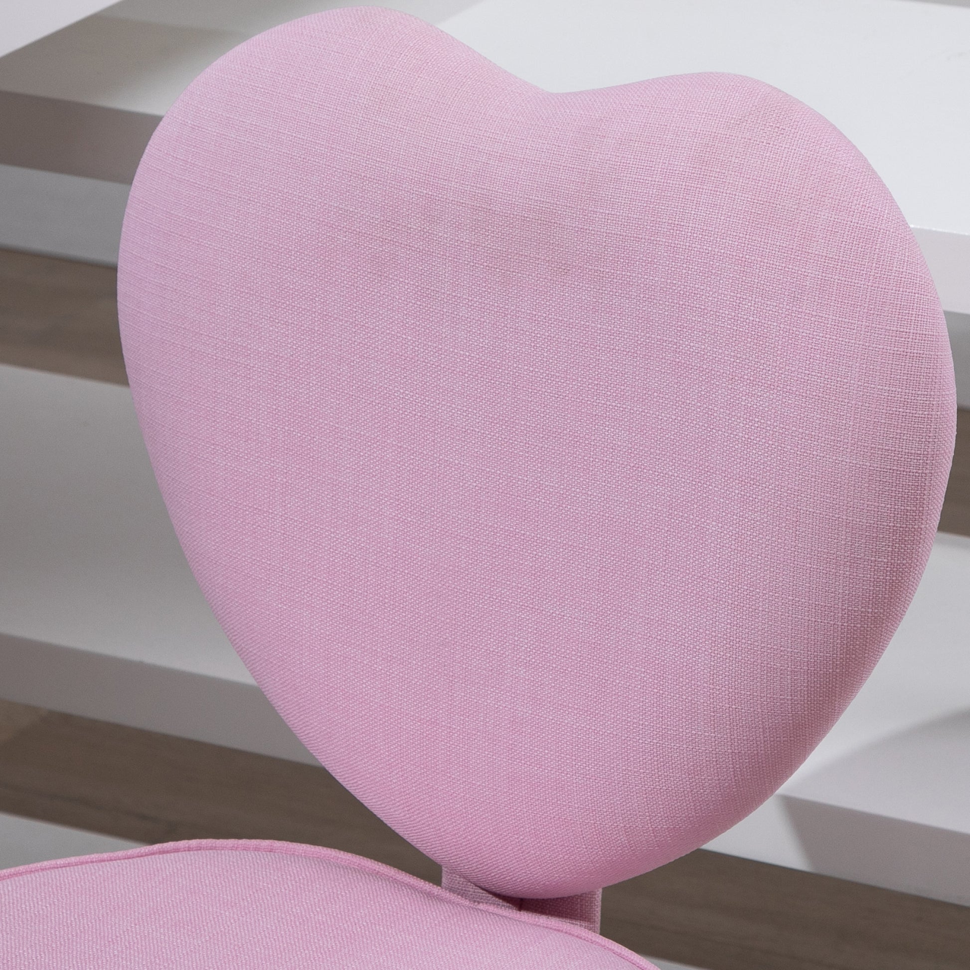 Pink upholstered heartshaped chair back for a childs desk