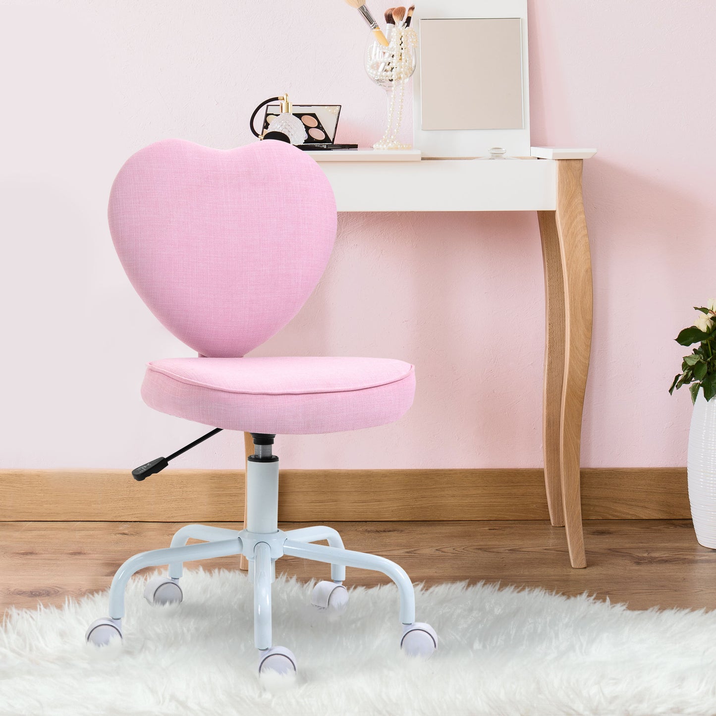 Pink heartshaped desk chair with adjustable height and rolling casters perfect for a vanity