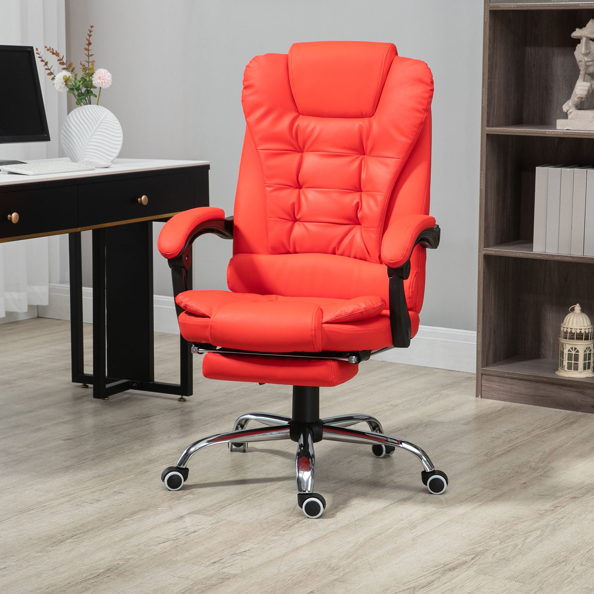 Ergonomic red executive office chair with padded seat and adjustable footrest