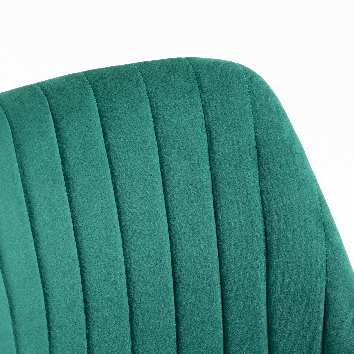 Closeup of a teal velvet chair back with vertical channel tufting for a luxurious feel