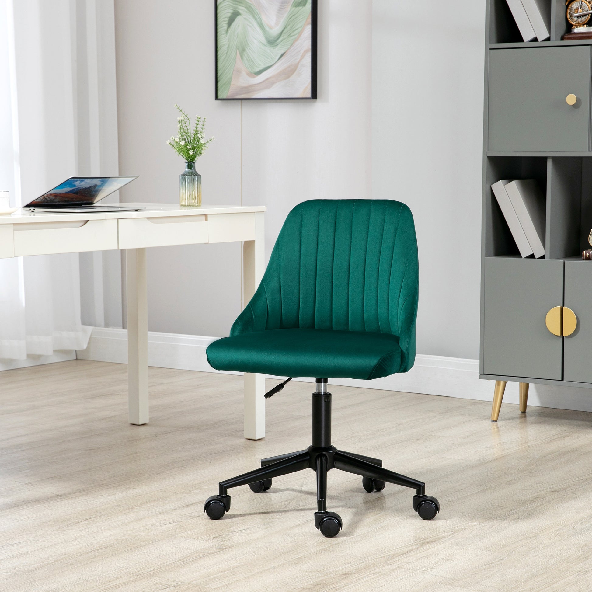 Emerald green velvet office chair with vertical tufting and black casters