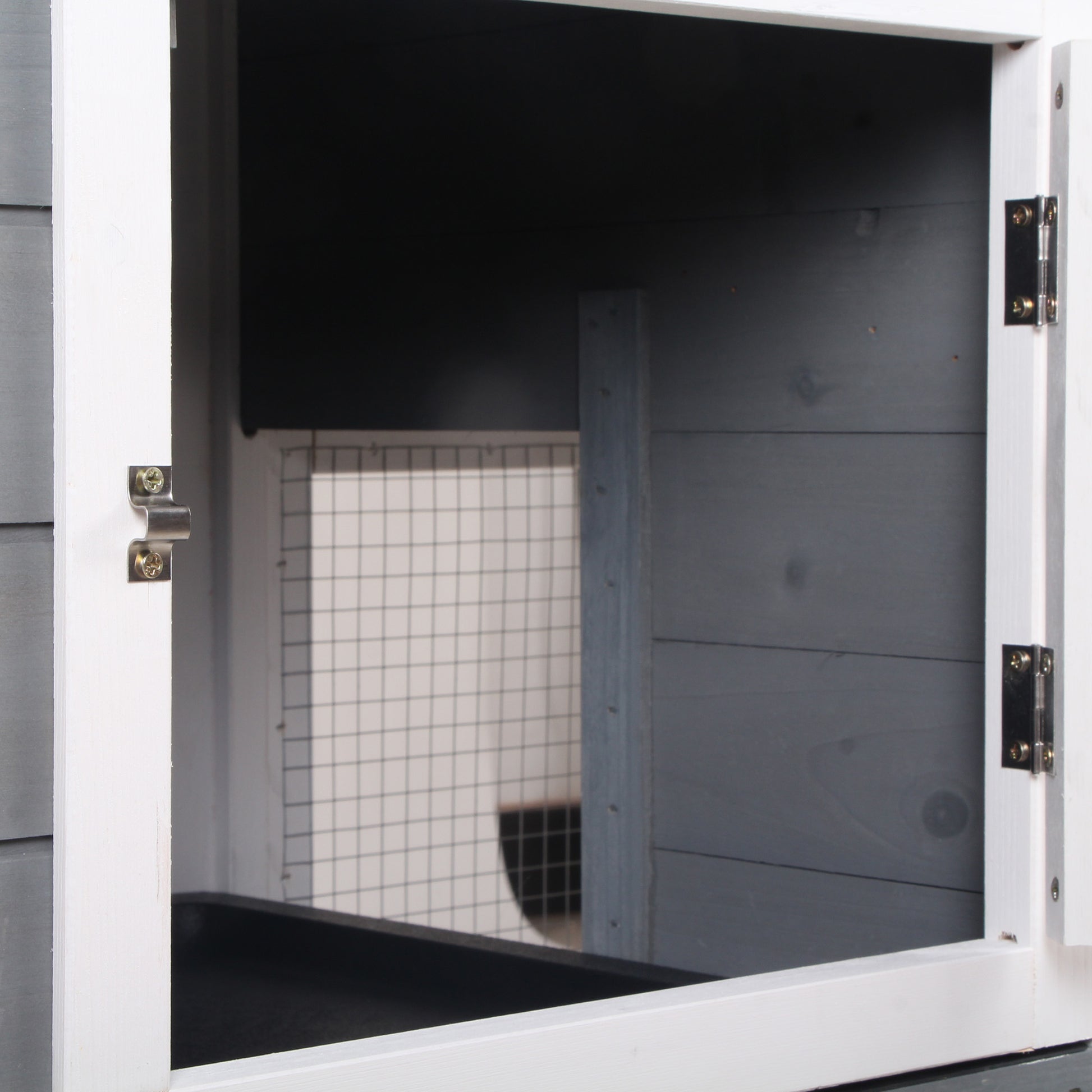 Closeup of an open wooden pet hutch door with wire mesh enclosure visible inside