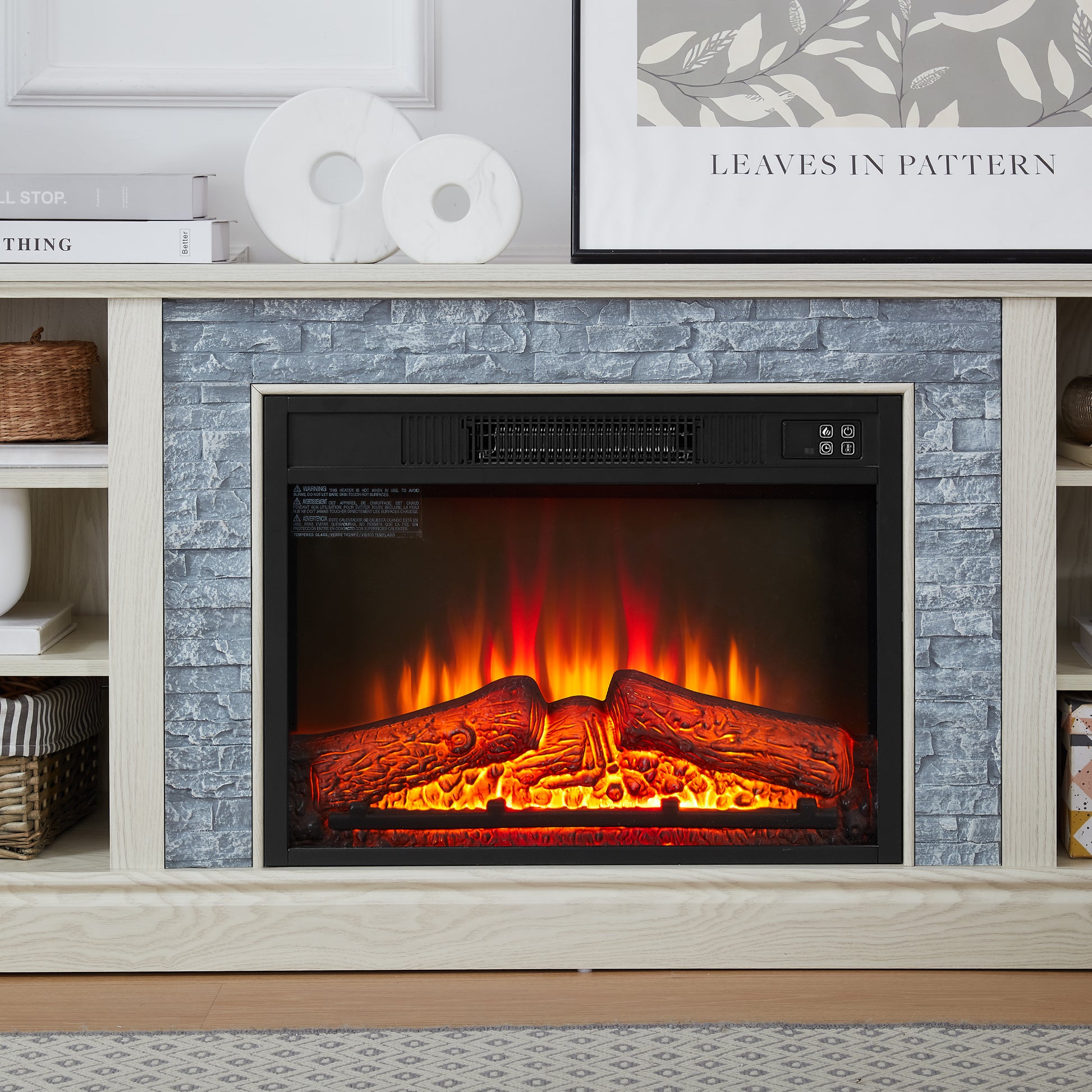 Electric fireplace with realistic glowing logs and vibrant flames white wood surround gray stone veneer