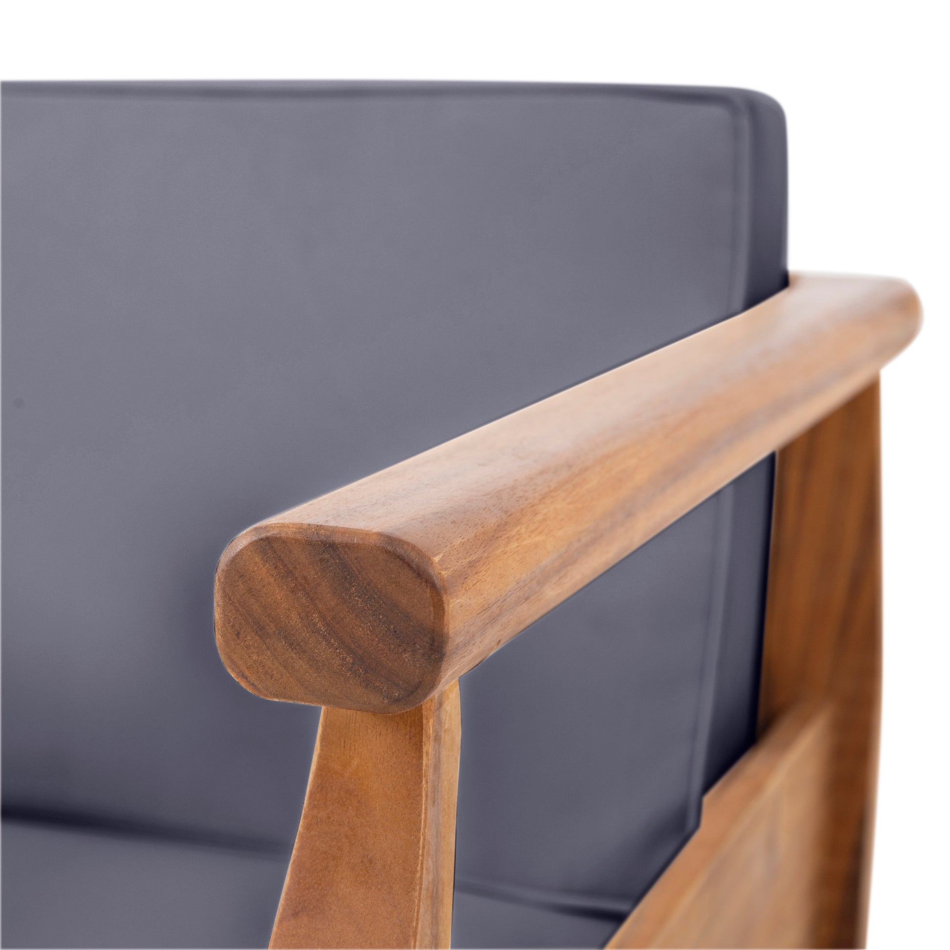 Closeup of a teak wood armrest on a gray upholstered accent chair