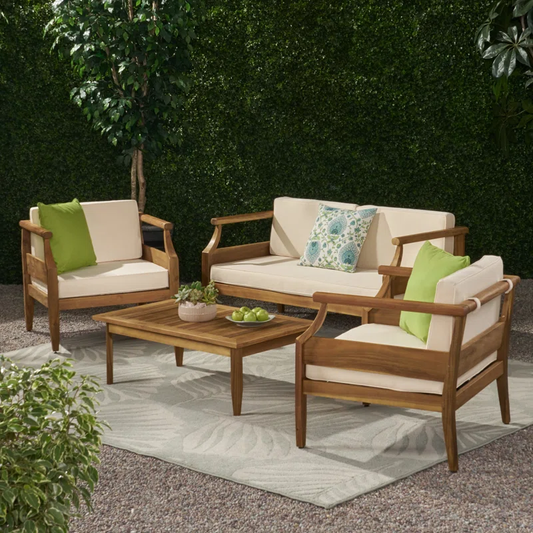 Acacia wood patio furniture set with cream cushions and green accent pillows
