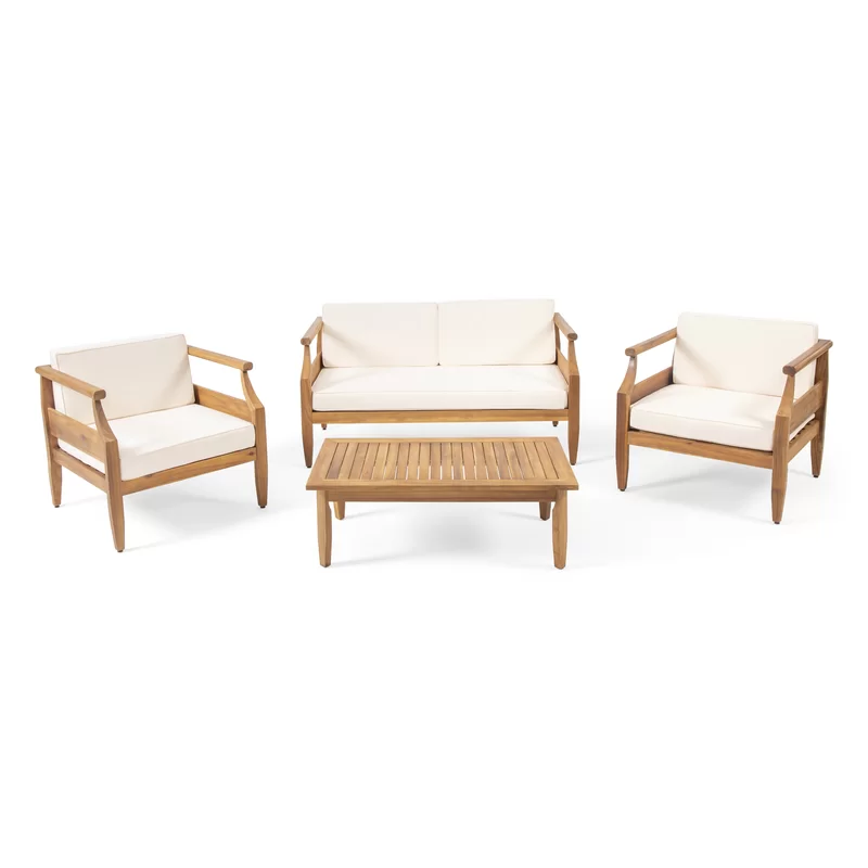 Teak wood outdoor furniture set with white cushions including sofa chair and coffee table