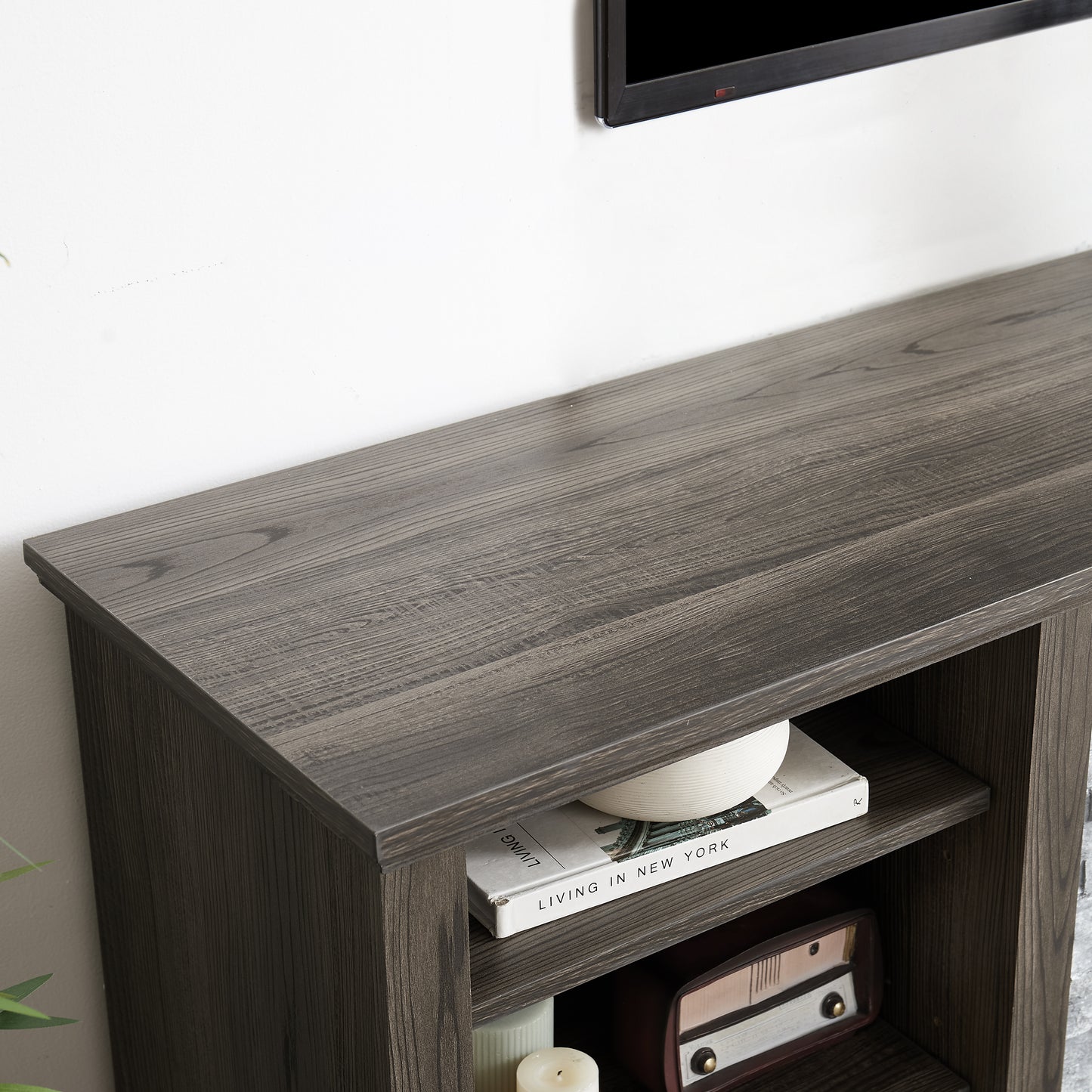 Dark oak veneer TV stand with open shelving and textured wood grain