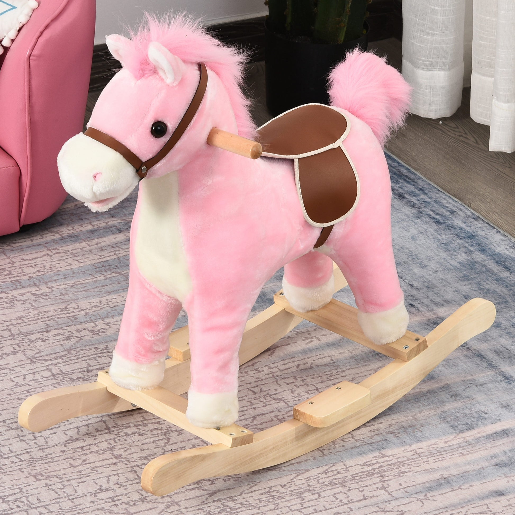 Pink plush rocking horse with brown saddle and wooden base for toddlers