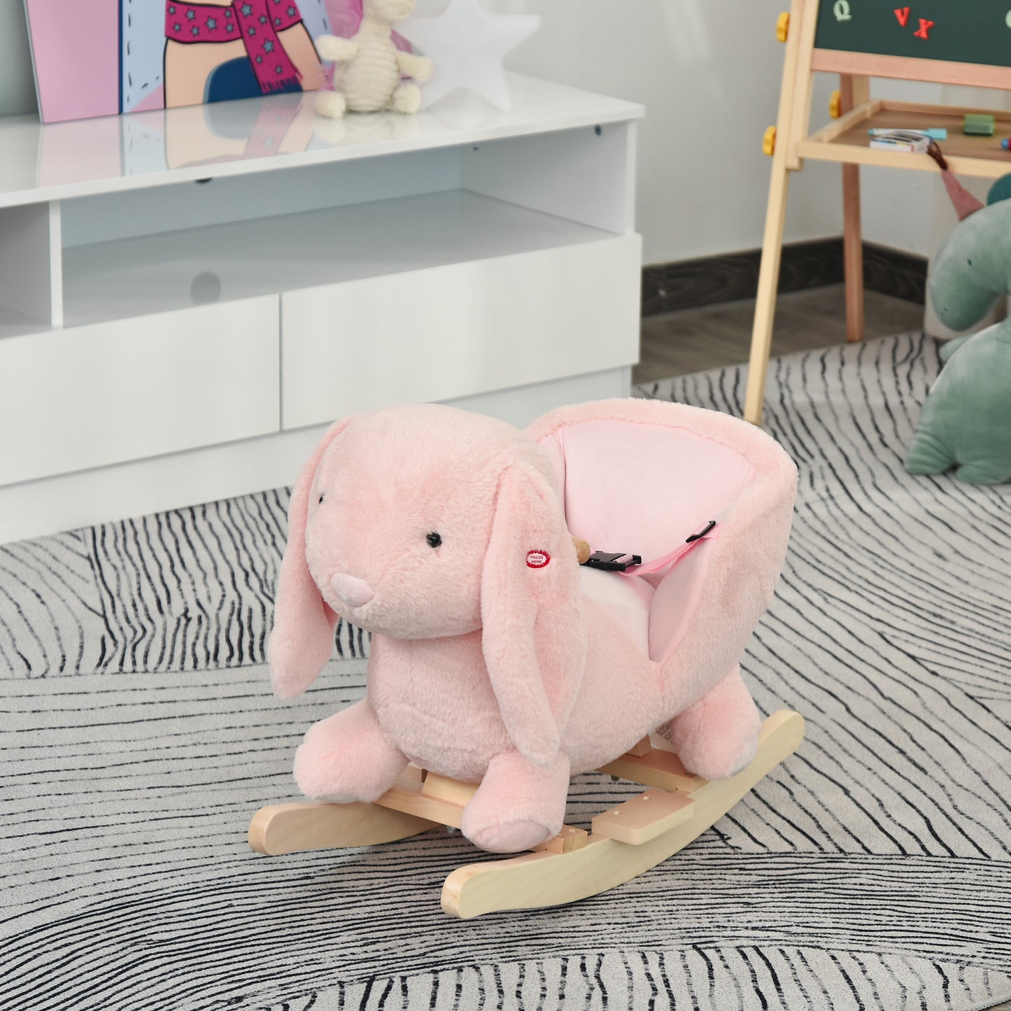 Plush pink bunny rocking horse for toddlers with wooden base and safety straps