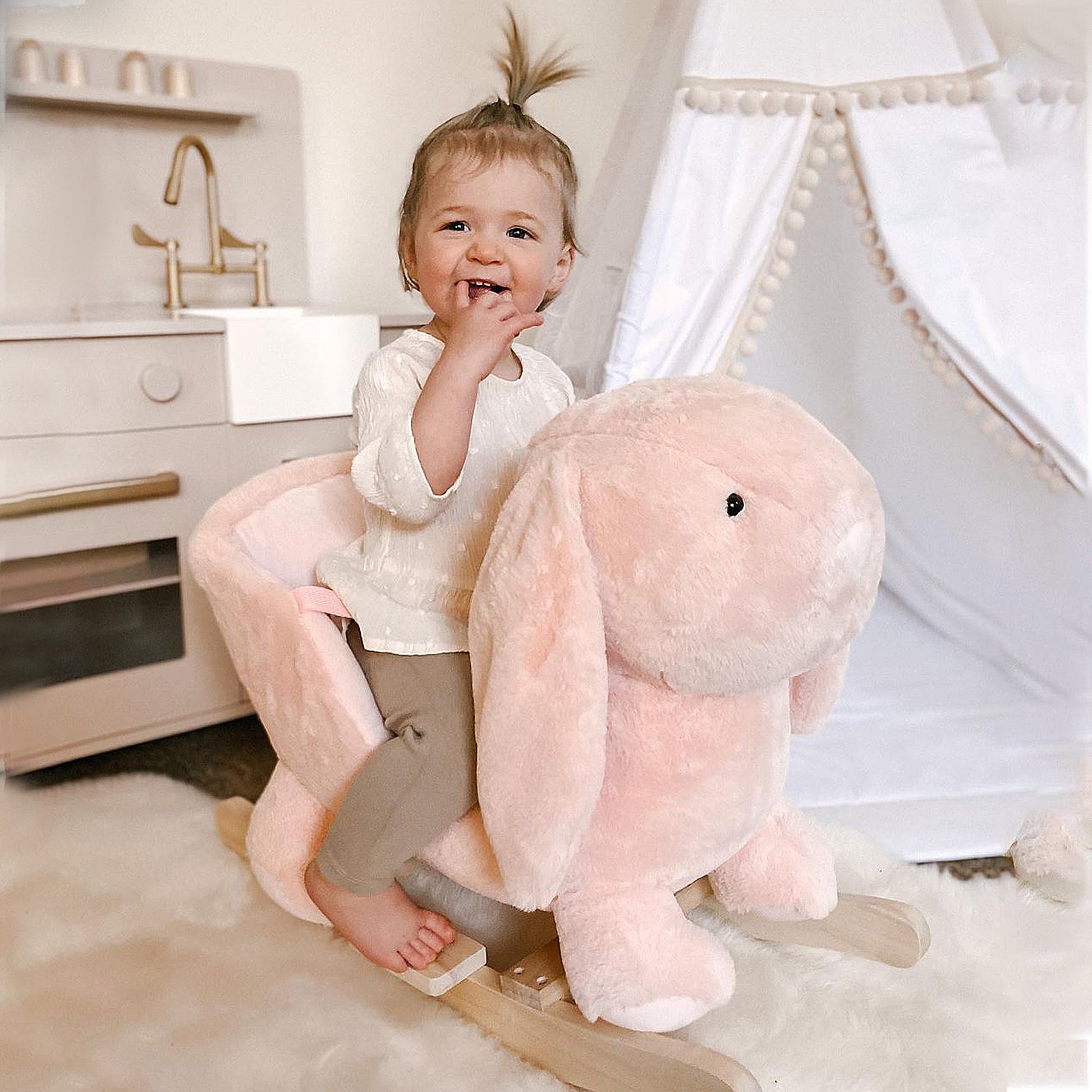 Plush pink bunny rocking horse for toddlers with wooden base ideal for nursery decor