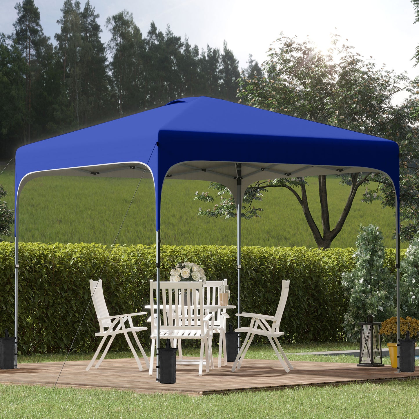 Royal blue x popup canopy tent providing shade for an outdoor patio set