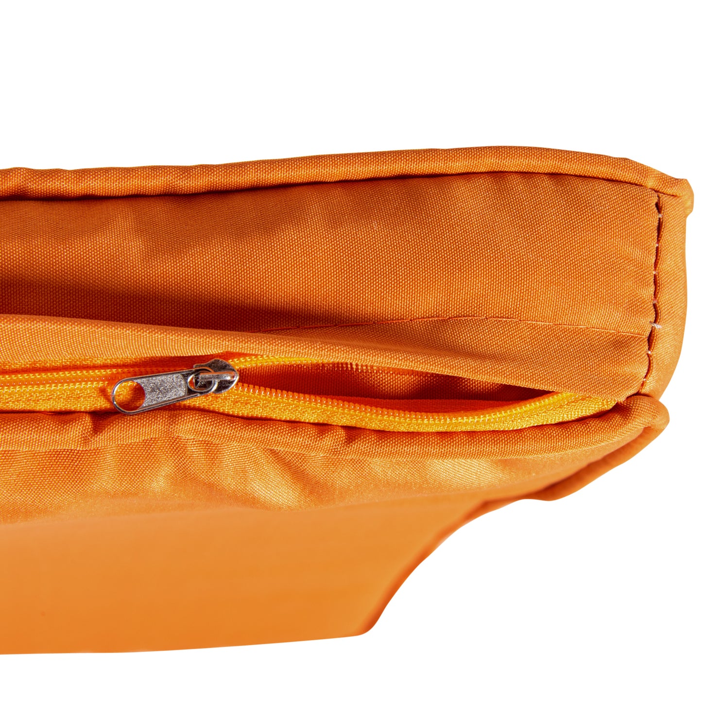 Closeup of an orange outdoor cushion fabric with a visible metal zipper detail