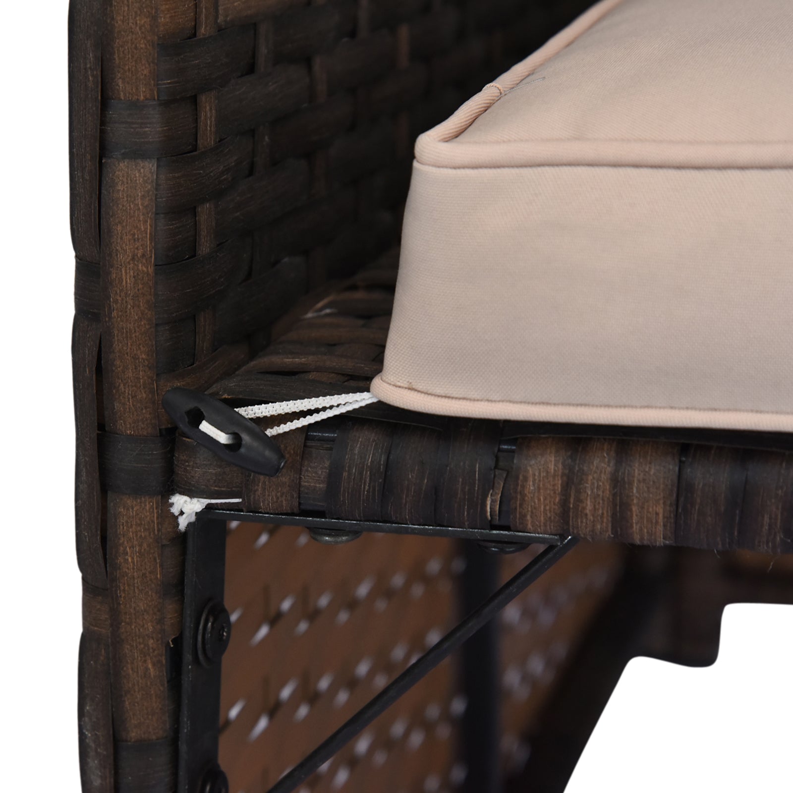 Dark brown rattan chair detail with tan cushion and black toggle tie down