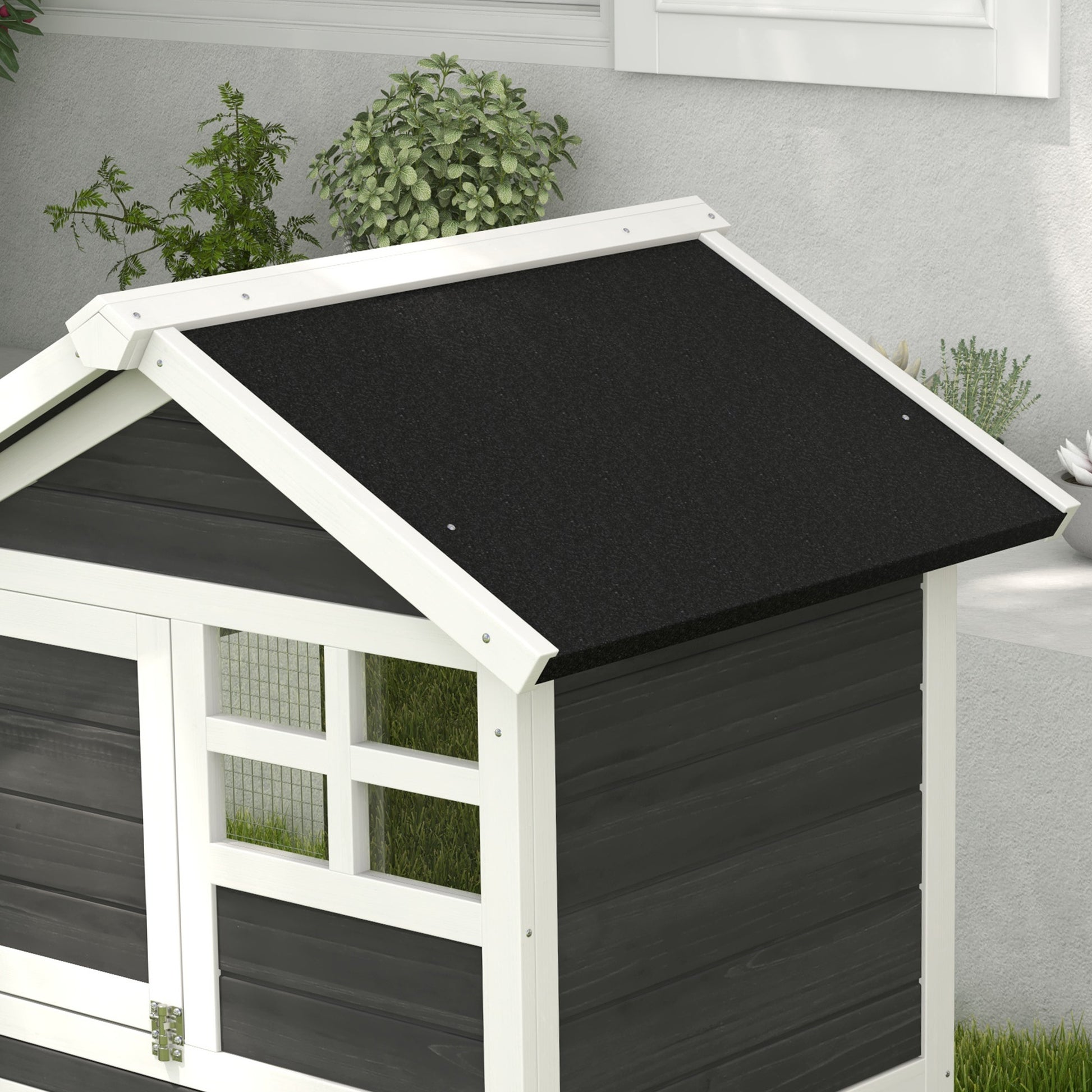 Wooden pet house with black asphalt roof and white trim ideal for small animals