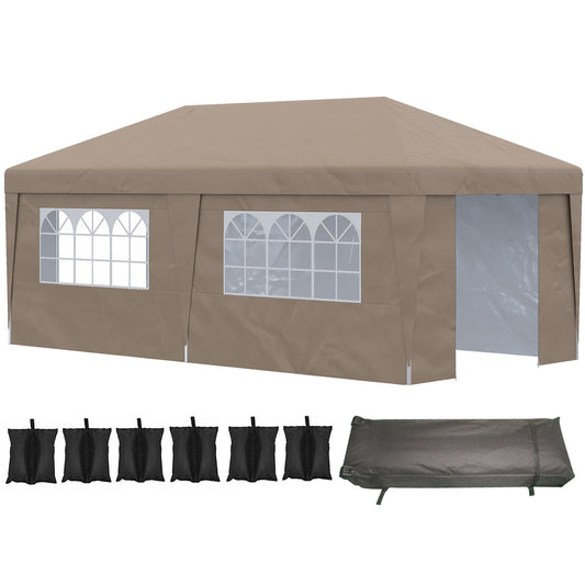 Tan canopy tent with arched windows and open entrance includes sandbags and storage cover