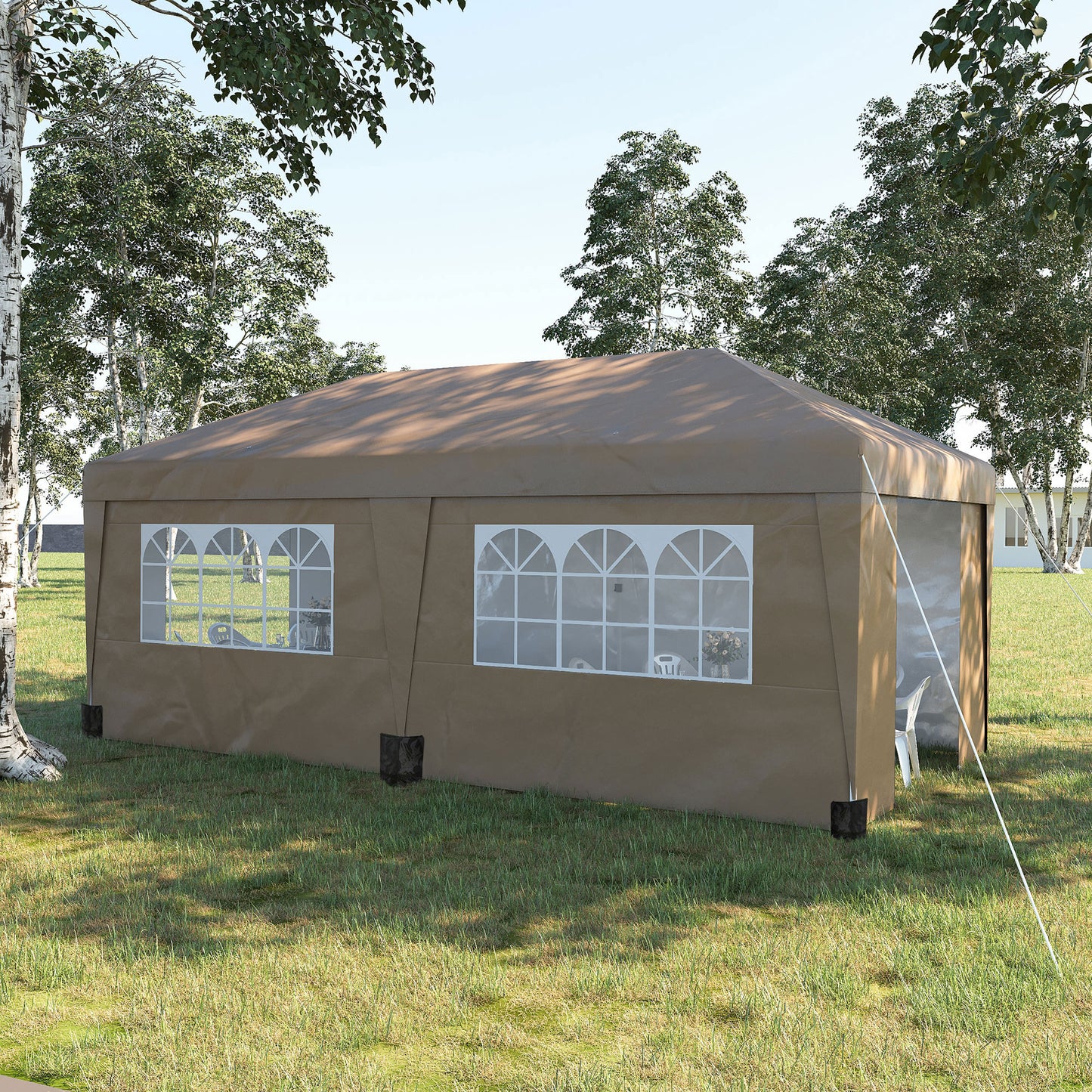Brown outdoor party tent with arched windows set up on a grassy lawn