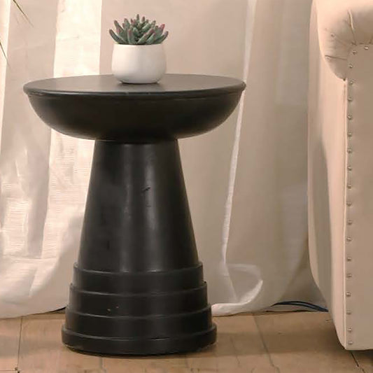 Modern black pedestal side table with a rounded top for drinks and decor