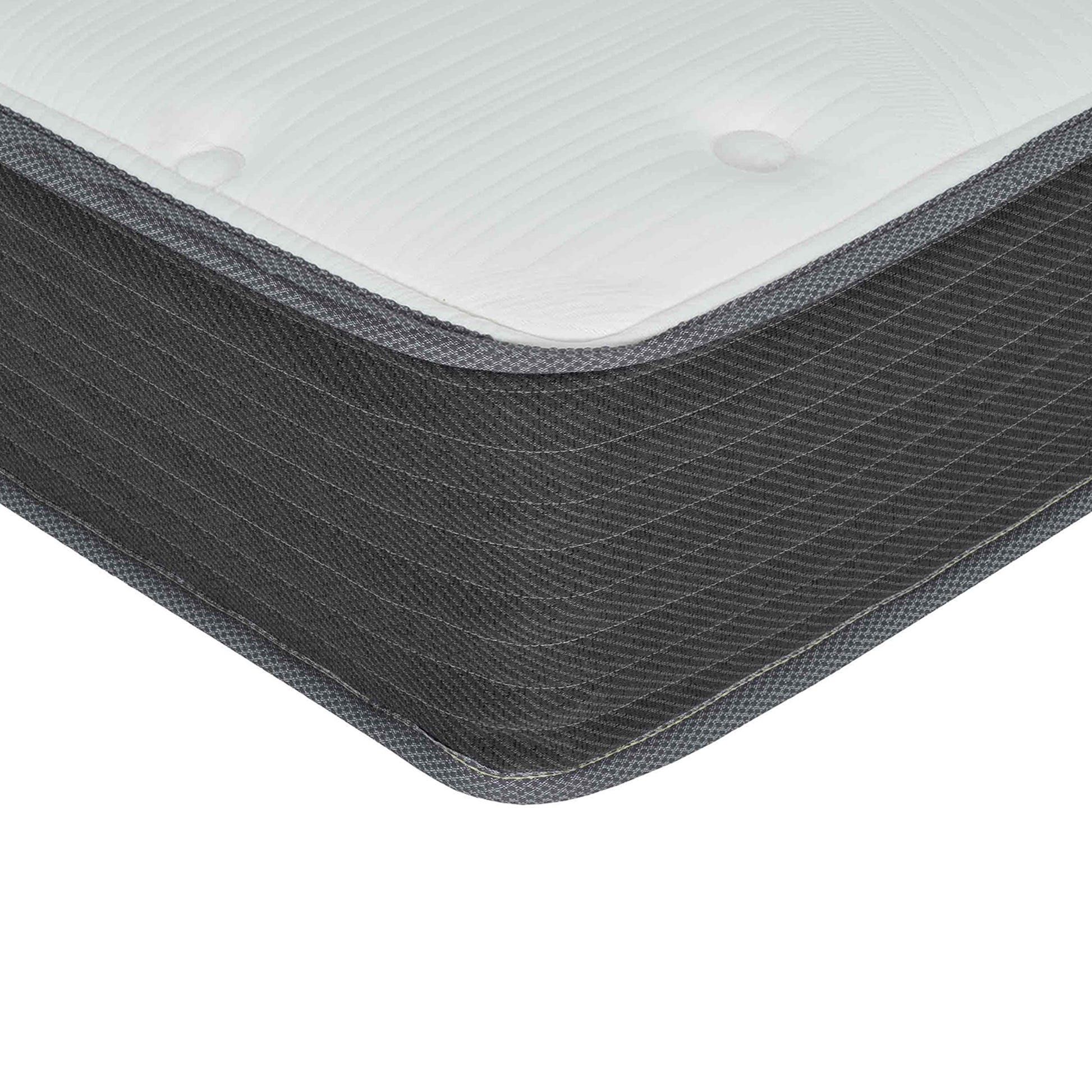 Closeup of a white quilted mattress with dark grey patterned side fabric for comfortable sleep